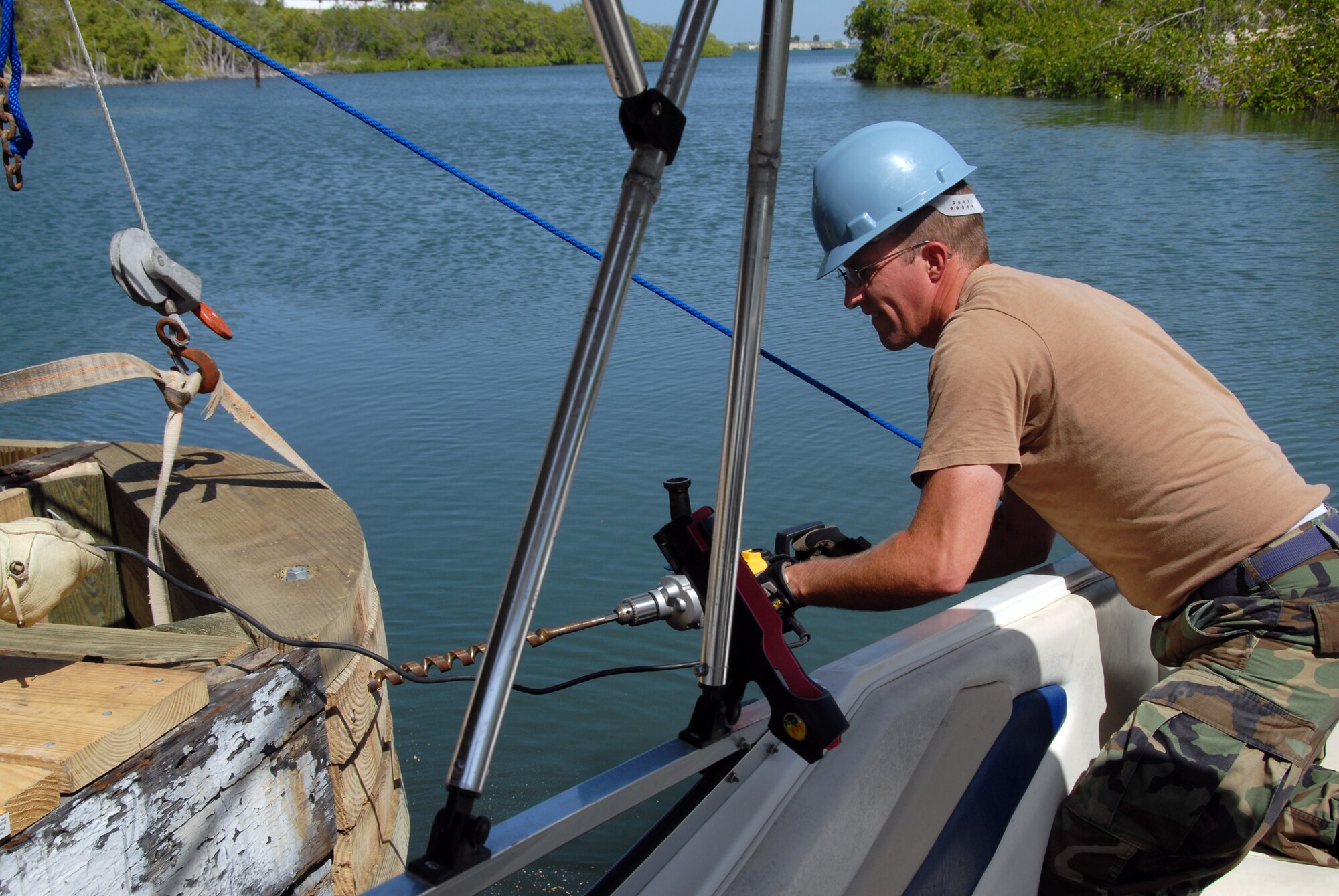 Air Force Staff Sgt. Merrill Brown, a carpenter with the Utah Air National Guard's 151st Civil Engineering Squadron, makes repairs to a dock during training at U.S. Naval Station Guantanamo Bay, Aug. 24, 2009. The 151st CES is conducting two weeks of annual training by completing engineering projects around the naval base for Joint Task Force Guantanamo. (JTF Guantanamo photo by Air Force Staff Sgt. Emily Monson) 