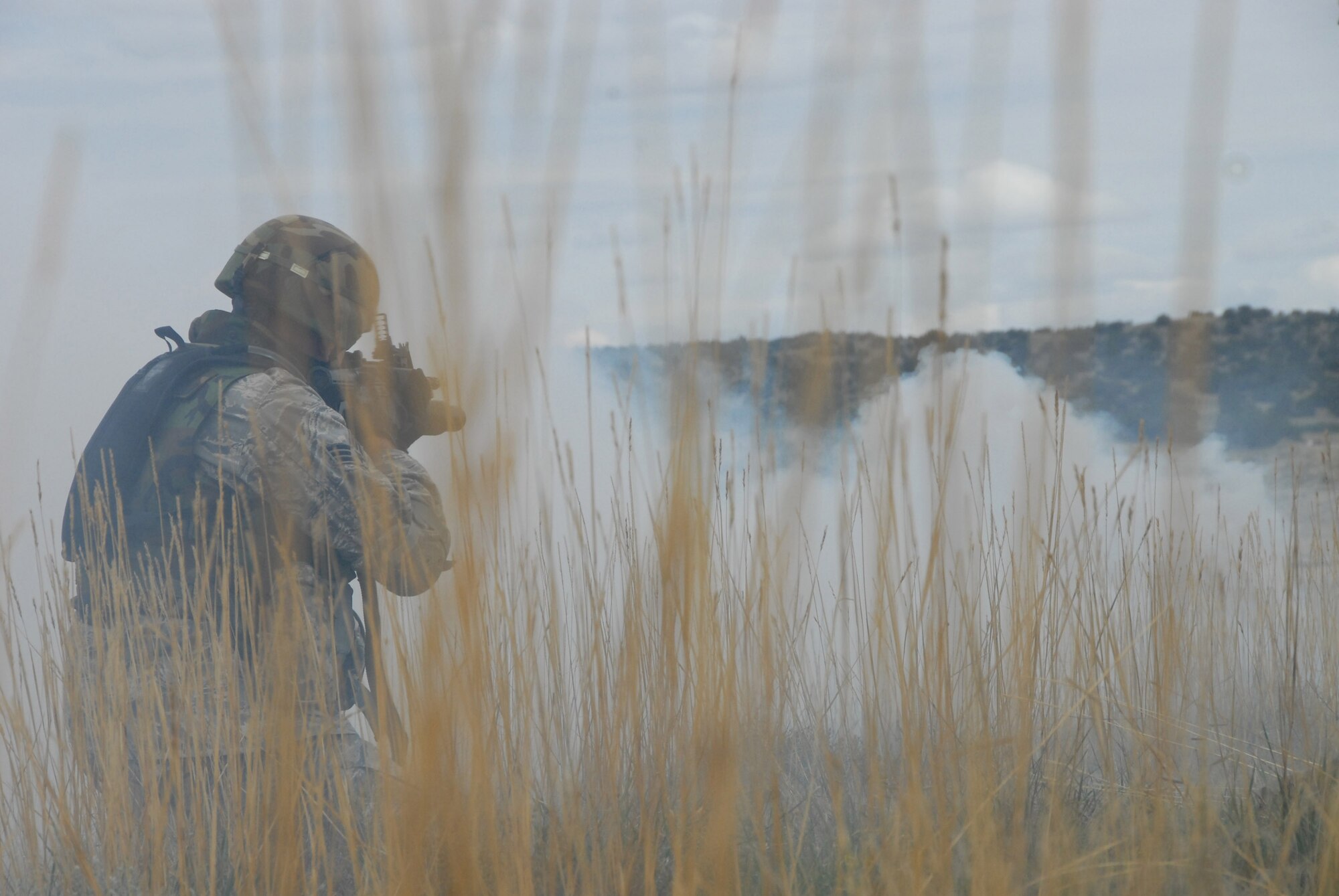 An Airman with the 140th Security Forces Squadron fires at targets during a live fire training exercise Sept. 12, 2009 at the Airburst Range in Fort Carson, Colo. Smoke and simulated enemy artillery fire are make the training more realistic. With changing times and ongoing warfare, security forces troops must be adaptable, and their new, more active combat roles make this training even more relevant. (Official U.S. Air Force photo by Staff Sgt. Armando Argiz, Colorado Air National Guard/Released)