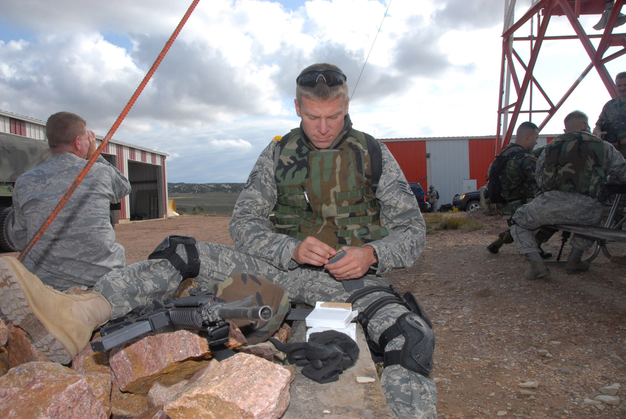 Colorado Air National Guard Staff Sgt. John Huntz, an Airman with the 140th Security Forces Squadron, takes a seat while he loads his rifle ammunition for a live fire training exercise Sept. 12, 2009 at the Airburst Rage in Fort Carson, Colo. The LFTX is a vital part of the Airman?s annual training, which will help make him a better equipped and knowledgeable Guardsman. (Official U.S. Air Force photo by Staff Sgt. Armando Argiz, Colorado Air National Guard/Released)