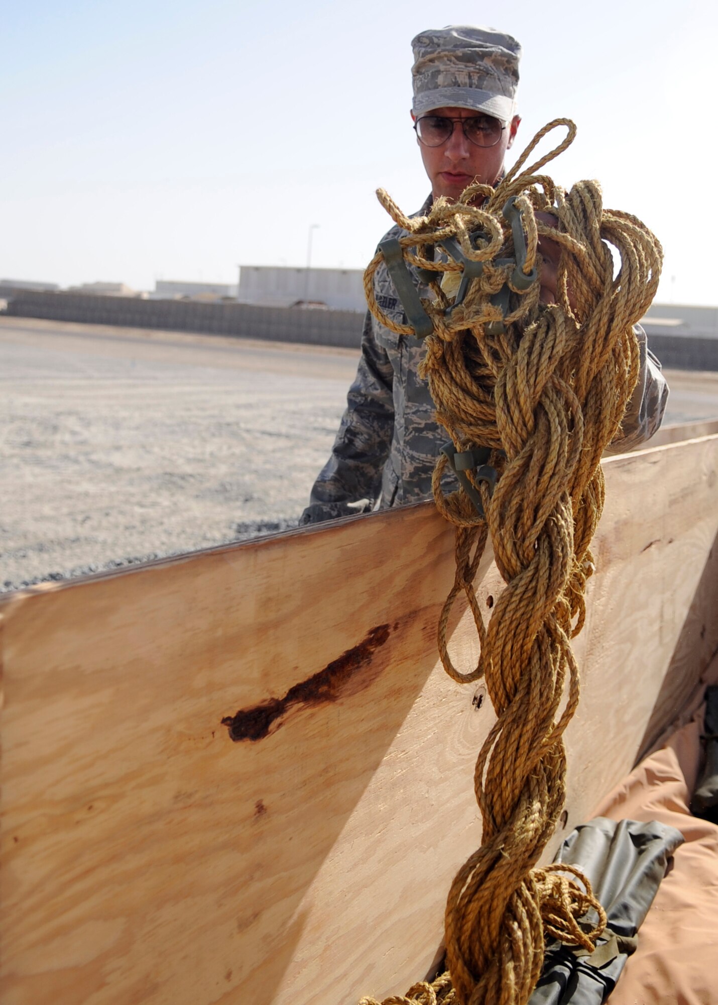 SOUTHWEST ASIA – Senior Airman Joseph Wheeler, 380th Expeditionary Civil Engineer Squadron, gets supplies while setting up tents Sept. 17, 2009. The tents will house transient Soldiers. Airman Wheeler is deployed from Travis Air Force Base, Calif., and grew up in Spartanburg, S.C. (U.S. Air Force photo/Senior Airman Stephen Linch) 