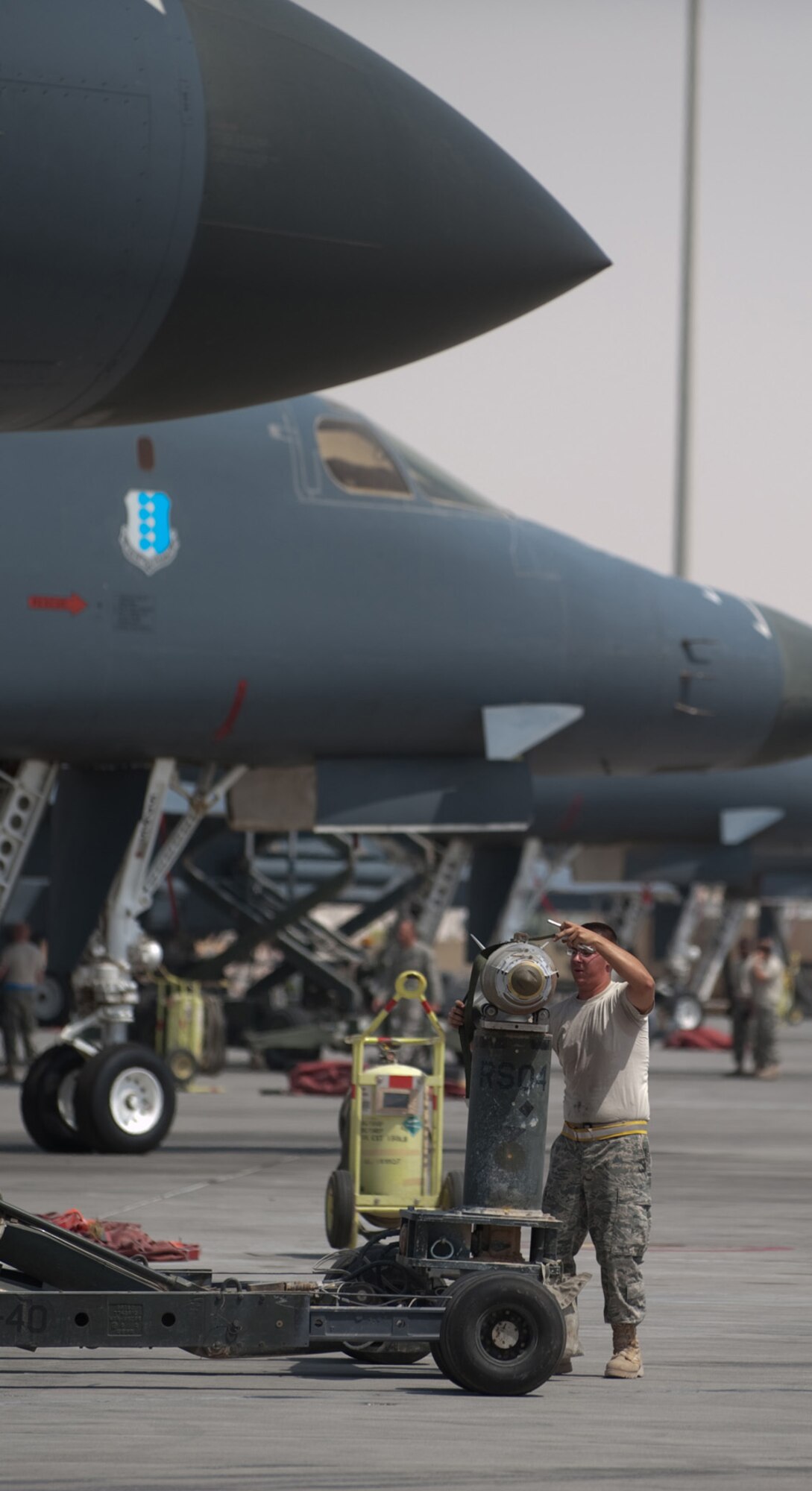 Airman 1st Class Brian Adkins, 37th Expeditionary Aircraft Maintenance Unit weapons load crew member, secures a GBU-38 to a MJ-40 bomb lift truck, Sept. 16, in Southwest Asia. The 37 EAMU weapons flight loaded mission-specific payloads into a B-1B Lancer for a sortie in the U.S. Air Forces Central Command area of responsibility. Airman Adkins is deployed from Ellsworth Air Force Base, S.D. in support of Operations Iraqi and Enduring Freedom. (U.S. Air Force photo/Staff Sgt. Robert Barney) 