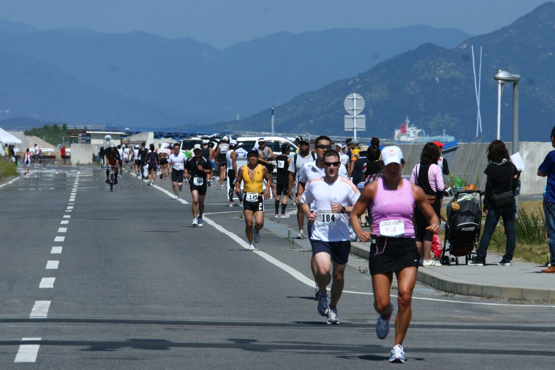 Hundreds of runners kick off the 22nd Annual Japanese and American Goodwill Sprint Triathlon together here Sunday. Camaraderie and good relations were more important than winning for some participants as they encouraged each other to keep on going and to complete the grueling race.