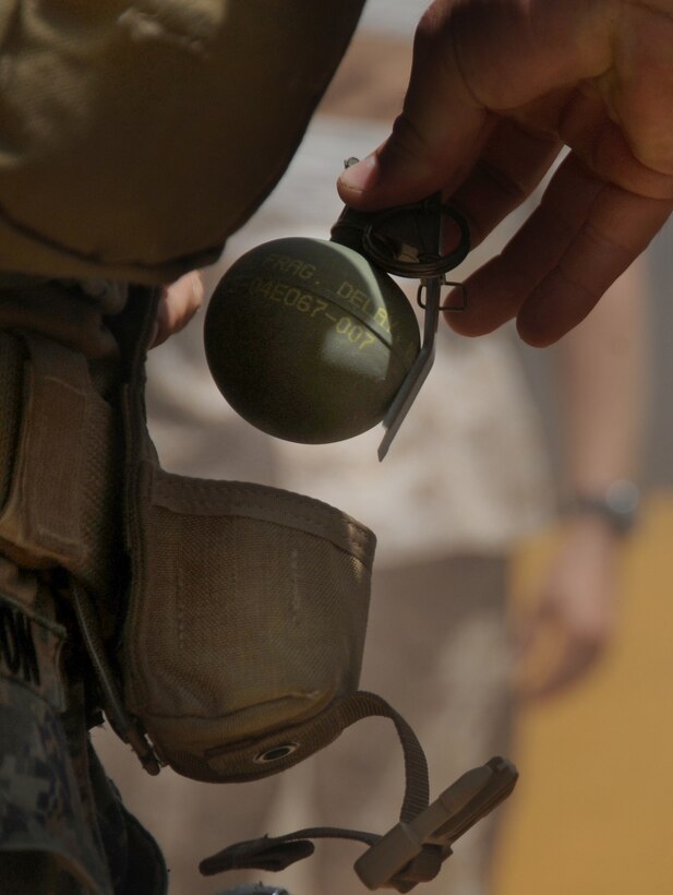 A Marine with the 11th Marine Expeditionary Unit’s reconnaissance platoon removes a fragmentation grenade from his grenade pouch prior to conducting a live-fire exercise here Sept. 20. The platoon was in Hawaii Sept. 17-22 for final training before deploying with the MEU Sept. 24.