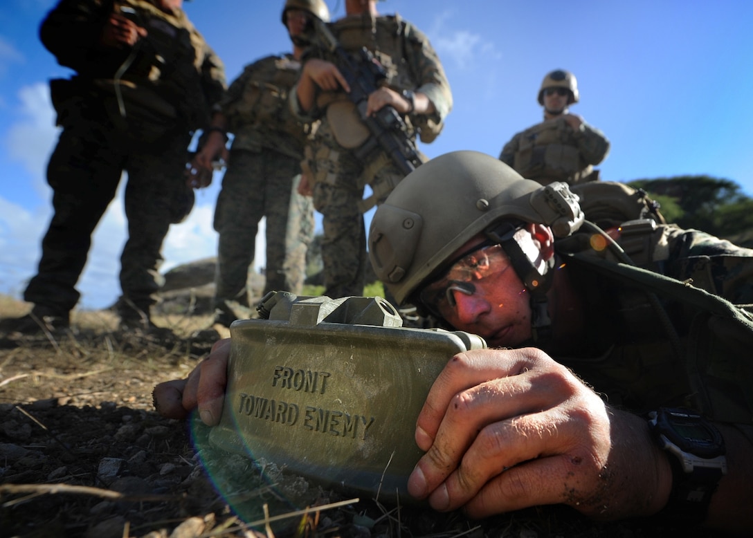 Sgt. Anthony Jacks emplaces a Claymore mine during a live-fire exercise here Sept. 20. Jacks and other Marines from Reconnaissance Platoon, Battalion Landing Team 2/4, 11th Marine Expeditionary Unit, practiced insertion methods and conducted live-fire weapon shoots Sept. 17-22 for final training before deploying with the MEU Sept. 24.