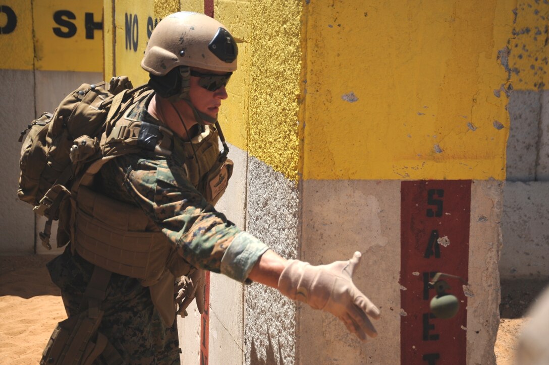 Cpl. Joe Missildine tosses a fragmentation grenade during a live-fire exercise here Sept. 20. Missildine and other Marines from Reconnaissance Platoon, Battalion Landing Team 2/4, 11th Marine Expeditionary Unit, practiced insertion methods and conducted live-fire weapon shoots Sept. 17-22 for final training before deploying with the MEU Sept. 24.