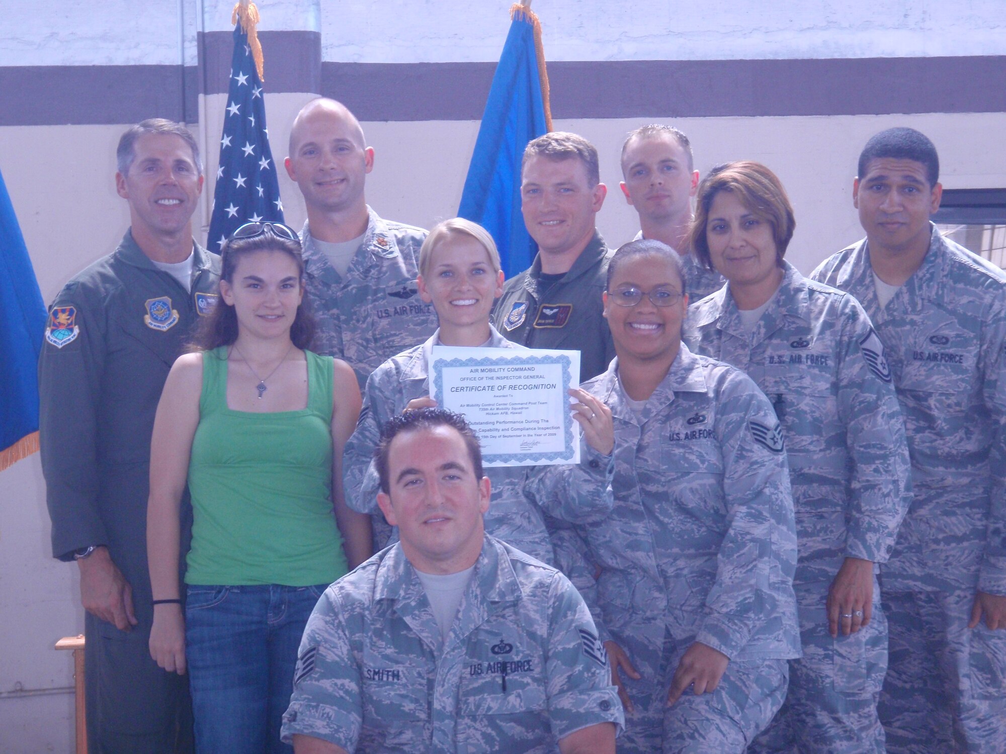 HICKAM AIR FORCE BASE, Hawaii -- Col. Richard McClain, 515th Air Mobility Operations Wing commander, presents the 735th Air Mobility Squadron team a
Certificate of Excellence from the Inspector General for their outstanding contributions during the Wing's En route Readiness Inspection Sept. 8-15. (Photo by Staff Sgt. Mary Kimberly)
