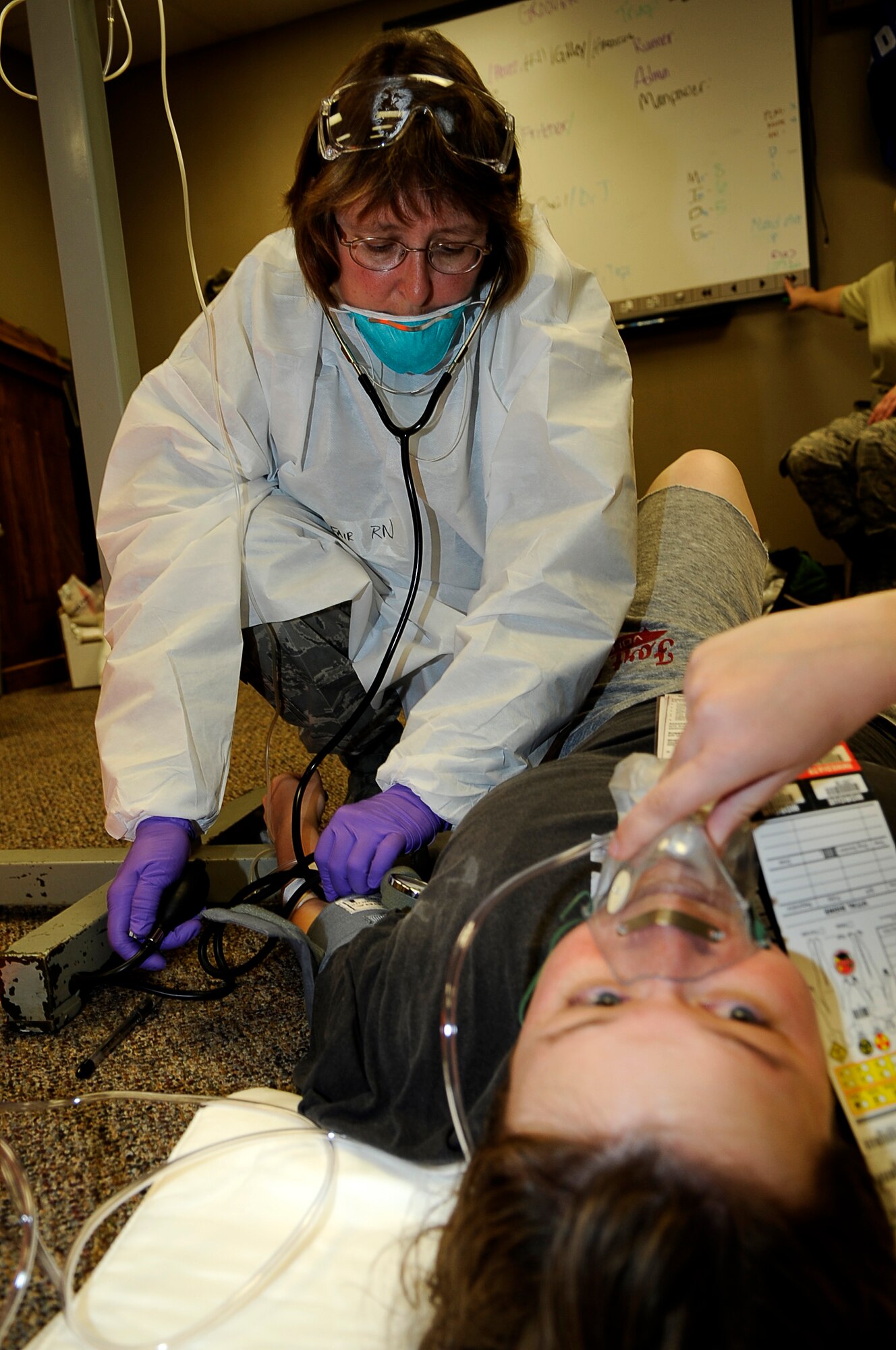 Maj. Vicki Fair, 460th Medical Group, cared for a bombing "victim" in a Sept. 18  medical exercise. (U.S. Air Force Photo by Tech. Sgt. Jeromy K. Cross)