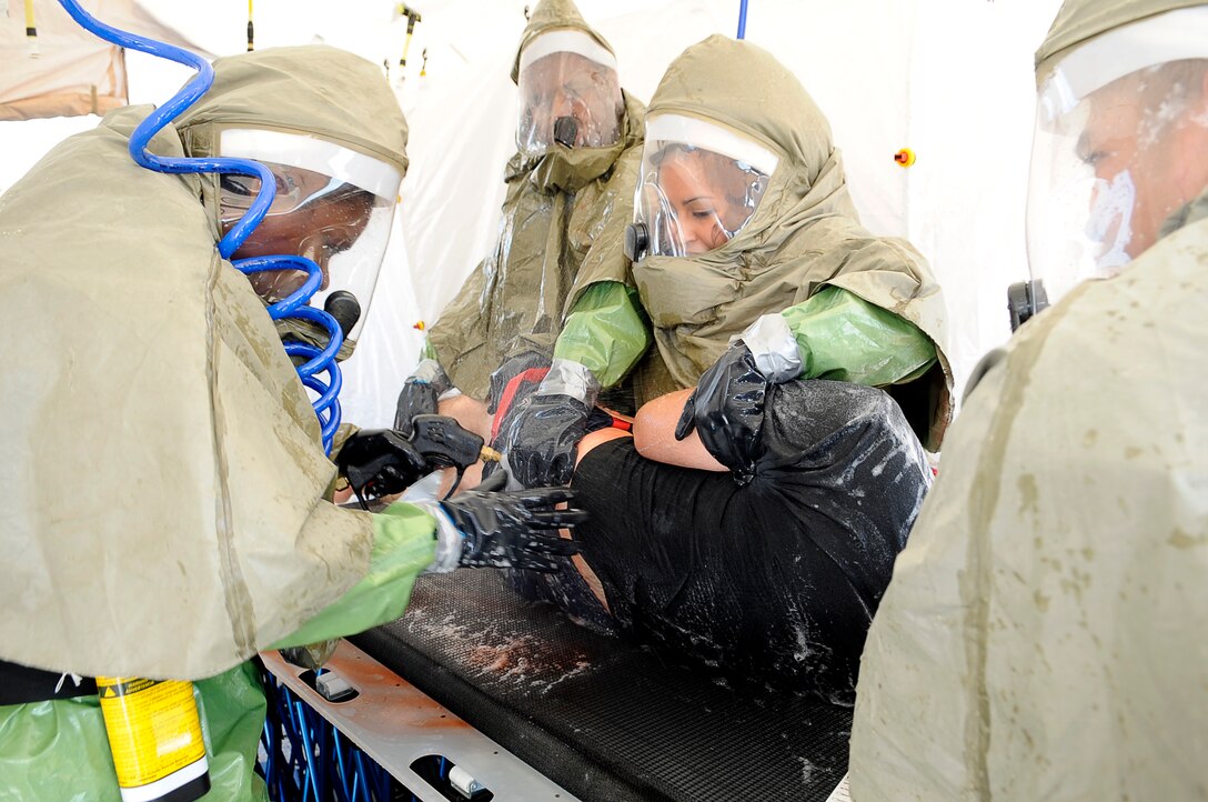 Buckley Airmen wash biological agents off a bombing "victim" during a recent medical response exercise. (U.S. Air Force Photo by Tech. Sgt. Jeromy K. Cross)