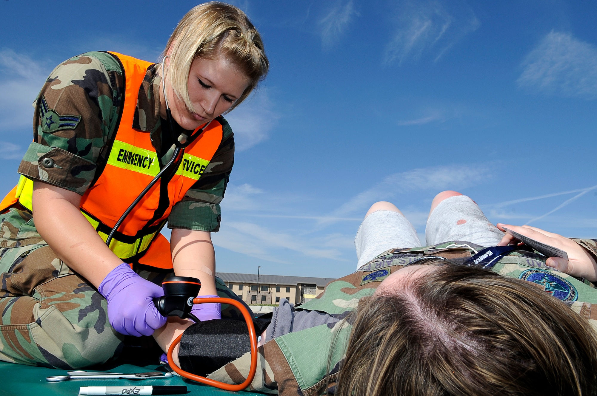 Airman 1st Class Christina Juarez, 460th Medical Group, provides medical attention to a bombing "victim" during a Sept. 18 medical exercise. (U.S. Air Force Photo by: Tech. Sgt. Jeromy K. Cross)