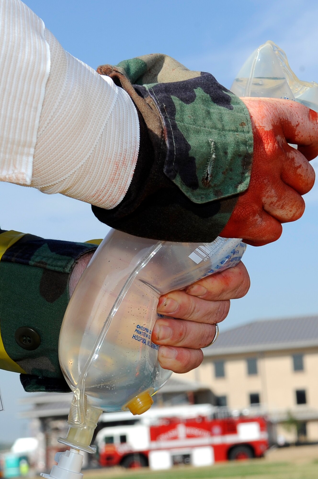 A“victim” of a car bomb holds an IV bag for another "victim" during an exercise at the 460th Space Wing, Buckley AFB., Colo in support of a Medical Emergency Response Capability Assessment and Training Sept. 18. (U.S. Air Force Photo by: Tech. Sgt. Jeromy K. Cross)