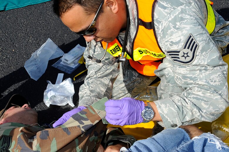 Staff Sgt. Danny Wong, 460th Medical Group, provides medical attention to a bombing victim in support of a Medical Emergency Response Capability Assessment and Training exercise Sept. 18.  More than 100 “victims” were treated during the exercise. (U.S. Air Force Photo by: Tech. Sgt. Jeromy K. Cross)