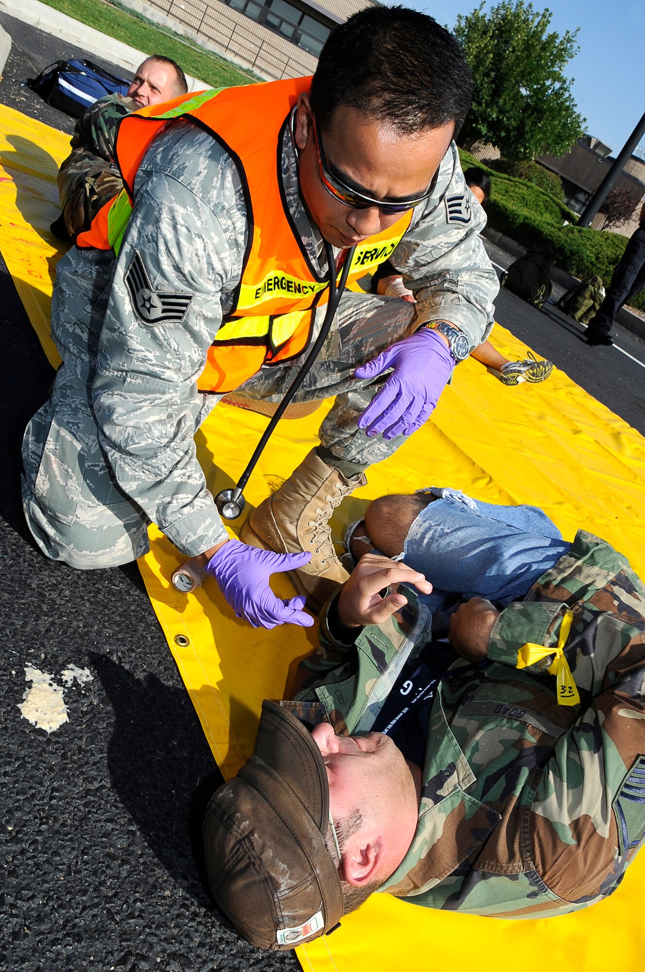 Staff Sgt. Danny Wong, 460th Medical Group, provides medical attention to a bombing victim in support of the MERCAT exercise Sept. 18. The MERCAT is designed to test home station capabilities. (U.S. Air Force Photo by: Tech. Sgt. Jeromy K. Cross)