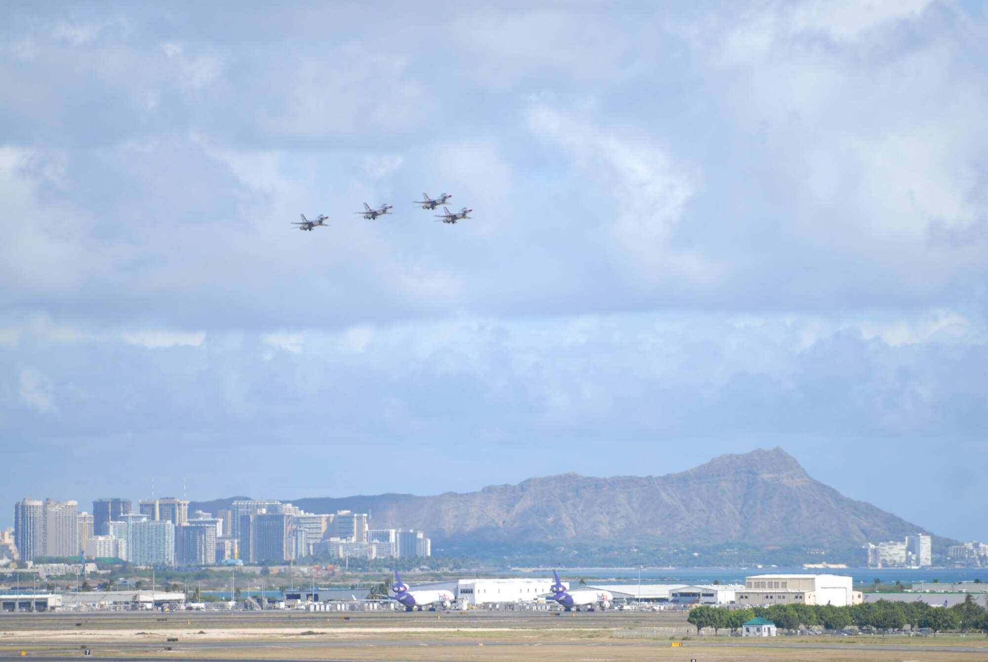 HICKAM AIR FORCE BASE, Hawaii -- Four Thunderbirds, U.S. Air Force Air Demonstration Squadron, with Waikiki and Daimondhead pictured in the backround, take off to begin their demonstration during the Open House, "Wings over the Pacific," here, Sep. 20. The Open House featured live band performances, static displays and The Thunderbirds demonstrated the capabilities of the F-16 Fighting Falcon when they preformed combat maneuvers at the air show. (U.S. Air Force photo/Senior Airman Gustavo Gonzalez)