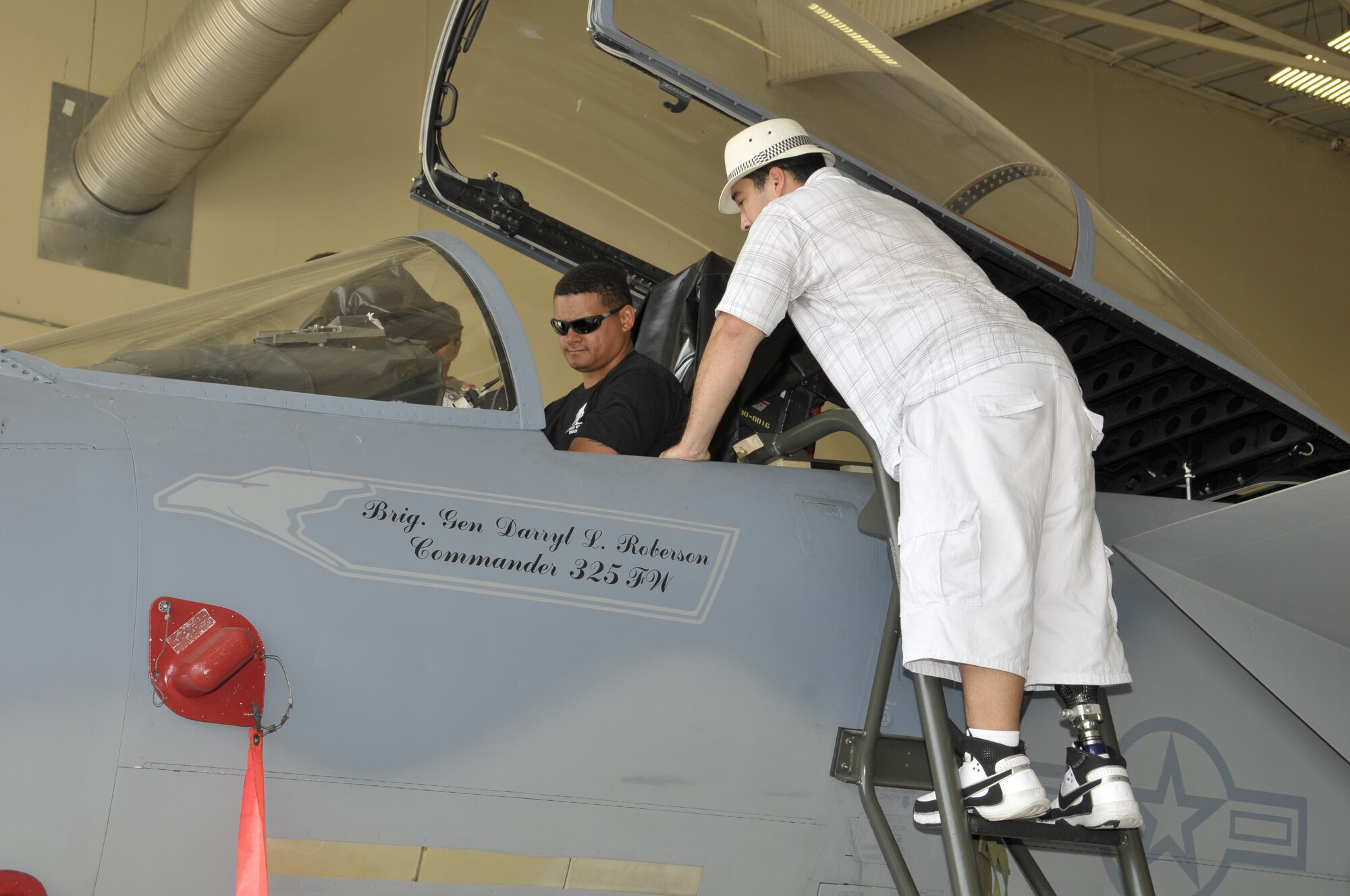 Former Marine Mike Owens and Army Staff Sgt. Conrad Calderon, both wounded warriors, tour Tyndall Air Force Base Sept. 16 while in the area on an ‘adaptive’ scuba diving trip.  The warriors were accompanied by the Red River Rats organization and were assisted by Tyndall Airmen in learning our mission and exploring our aircraft.  (U.S. Air Force photo/Lisa Norman)  