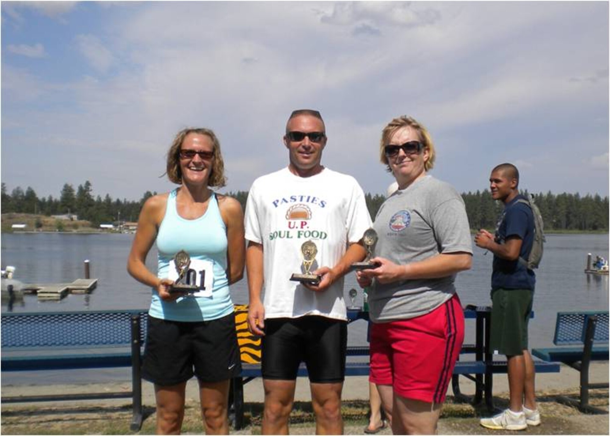 Maj. Sandy Smith, 141 FSF commander, Col. Robert Aunan, 141 ARW vice commander, and MSgt Gladys Shirey, 141 ARW retention office manager, hold trophies won after taking first place in the relay division at the 2009 Clear Lake Triathlon. The triathlon was hosted by the 92nd Force Support Squadron.