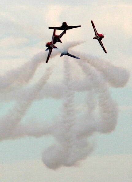 CT-114 Tutor planes from the Canadian Forces Snowbirds aerial demonstration team hold a demonstration event during the 2009 Scott Air Force Base Airshow on Sept. 19, 2009, at Scott AFB, Ill.  The airshow drew tens of thousands of people and featured a wide variety of aircraft on static display and in aerial performances.  (U.S. Air Force Photo/Tech. Sgt. Scott T. Sturkol)