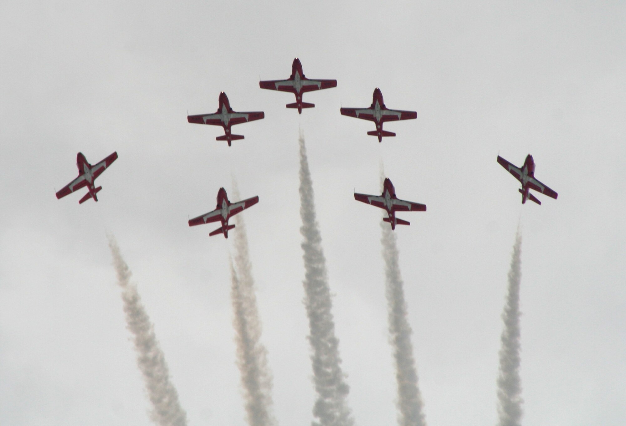 CT-114 Tutor planes from the Canadian Forces Snowbirds aerial demonstration team hold a demonstration event during the 2009 Scott Air Force Base Airshow on Sept. 19, 2009, at Scott AFB, Ill.  The airshow drew tens of thousands of people and featured a wide variety of aircraft on static display and in aerial performances.  (U.S. Air Force Photo/Tech. Sgt. Scott T. Sturkol)