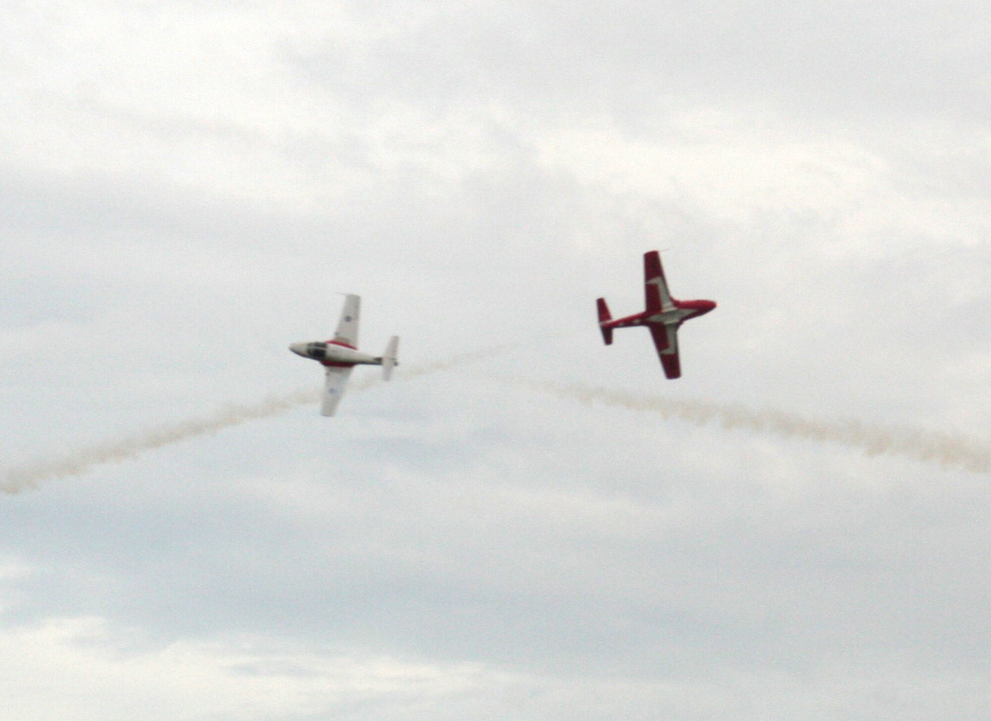 CT-114 Tutor planes from the Canadian Forces Snowbirds aerial demonstration team hold a demonstration event during the 2009 Scott Air Force Base Airshow on Sept. 19, 2009, at Scott AFB, Ill.  The airshow drew tens of thousands of people and featured a wide variety of aircraft on static display and in aerial performances.  (U.S. Air Force Photo/Tech. Sgt. Scott T. Sturkol)