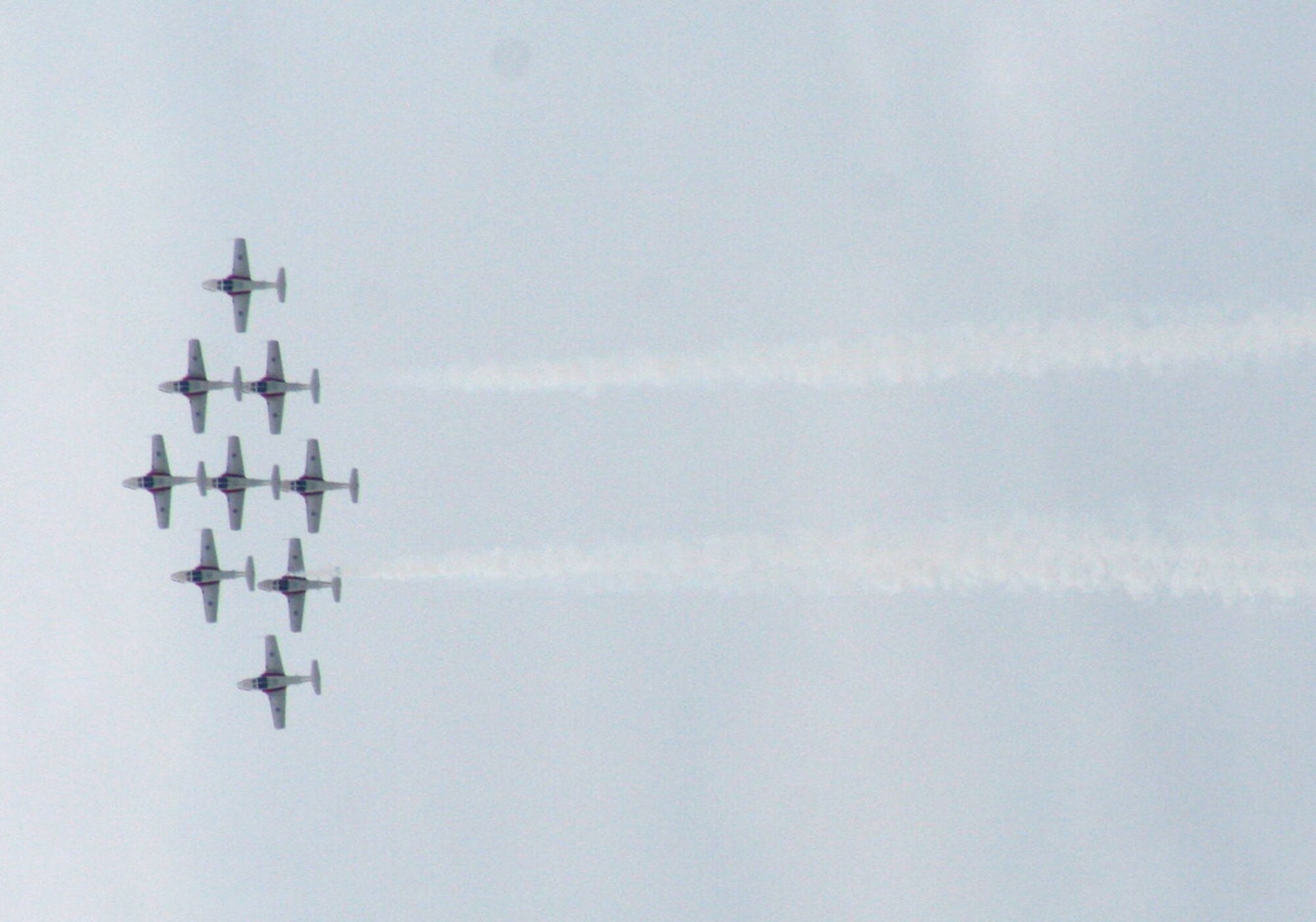 CT-114 Tutor planes from the Canadian Forces Snowbirds aerial demonstration team hold a demonstration event during the 2009 Scott Air Force Base Airshow on Sept. 19, 2009, at Scott AFB, Ill.  The airshow drew tens of thousands of people and featured a wide variety of aircraft on static display and in aerial performances.  (U.S. Air Force Photo/Tech. Sgt. Scott T. Sturkol)
