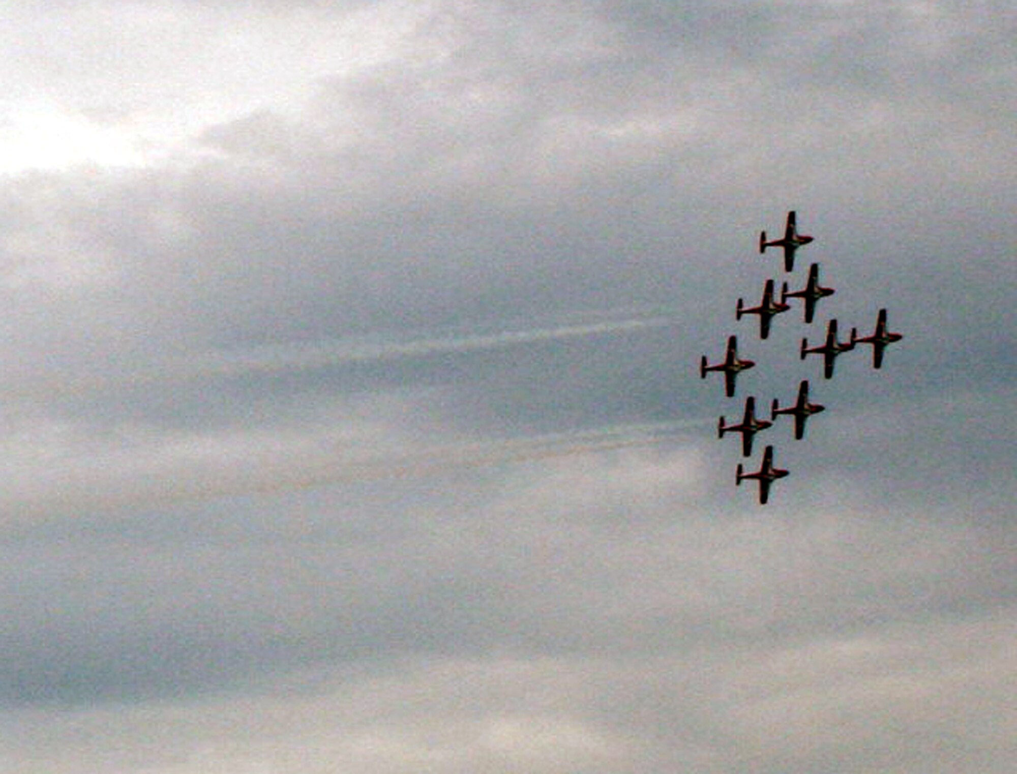 Nine CT-114 Tutor planes from the Canadian Forces Snowbirds aerial demonstration team hold a demonstration event during the 2009 Scott Air Force Base Airshow on Sept. 19, 2009, at Scott AFB, Ill.  The airshow drew tens of thousands of people and featured a wide variety of aircraft on static display and in aerial performances.  (U.S. Air Force Photo/Tech. Sgt. Scott T. Sturkol)