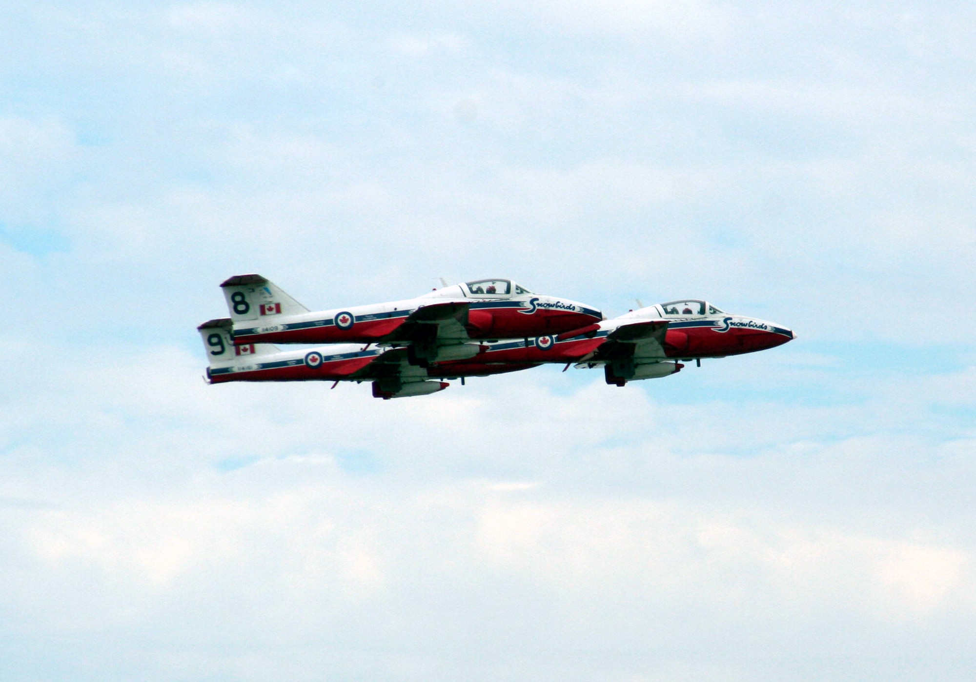 Three CT-114 Tutor planes from the Canadian Forces Snowbirds aerial demonstration team take off for a demonstration event during the 2009 Scott Air Force Base Airshow on Sept. 19, 2009, at Scott AFB, Ill.  The airshow drew tens of thousands of people and featured a wide variety of aircraft on static display and in aerial performances.  (U.S. Air Force Photo/Tech. Sgt. Scott T. Sturkol)
