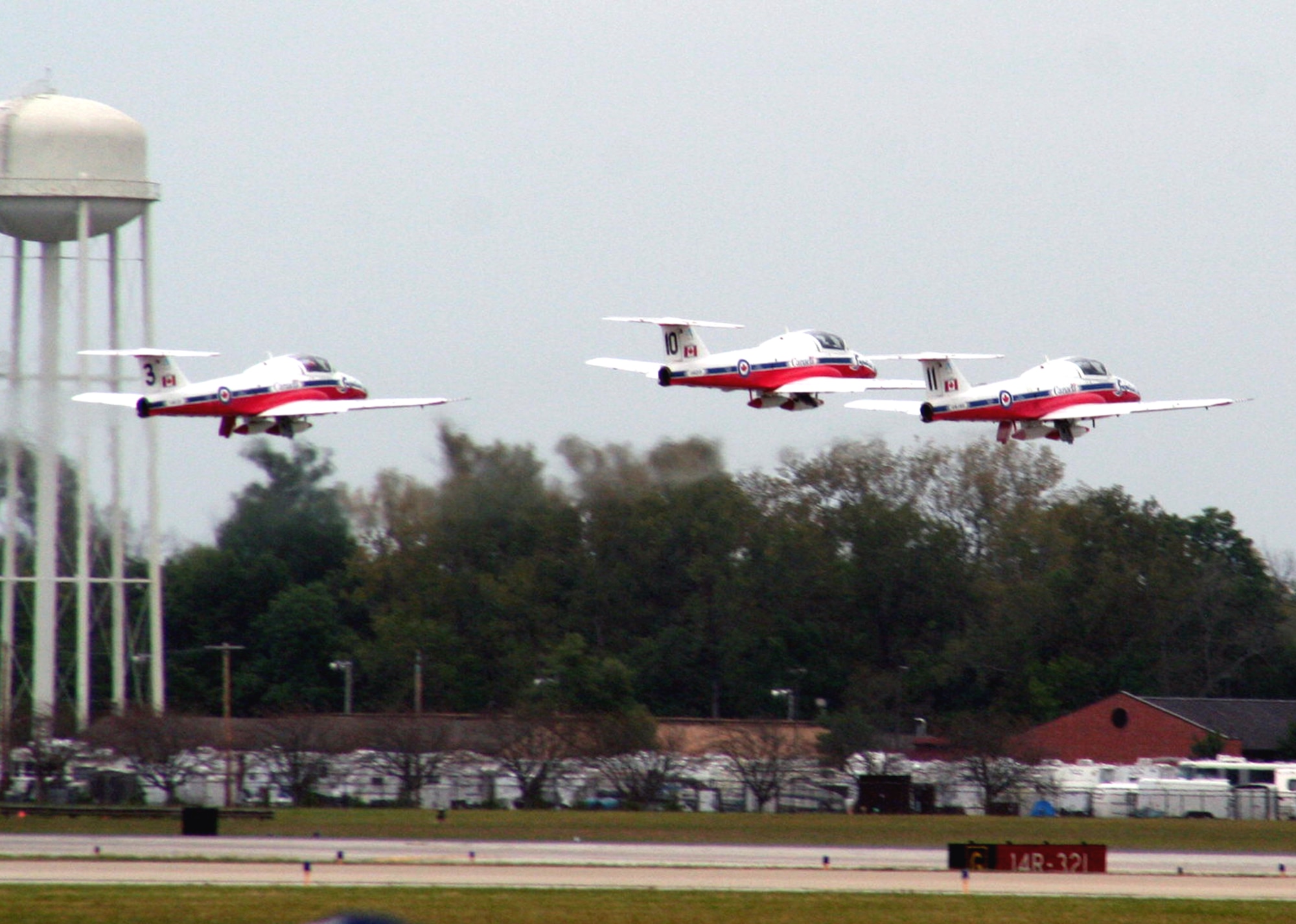 Three CT-114 Tutor planes from the Canadian Forces Snowbirds aerial demonstration team take off for a demonstration event during the 2009 Scott Air Force Base Airshow on Sept. 19, 2009, at Scott AFB, Ill.  The airshow drew tens of thousands of people and featured a wide variety of aircraft on static display and in aerial performances.  (U.S. Air Force Photo/Tech. Sgt. Scott T. Sturkol)