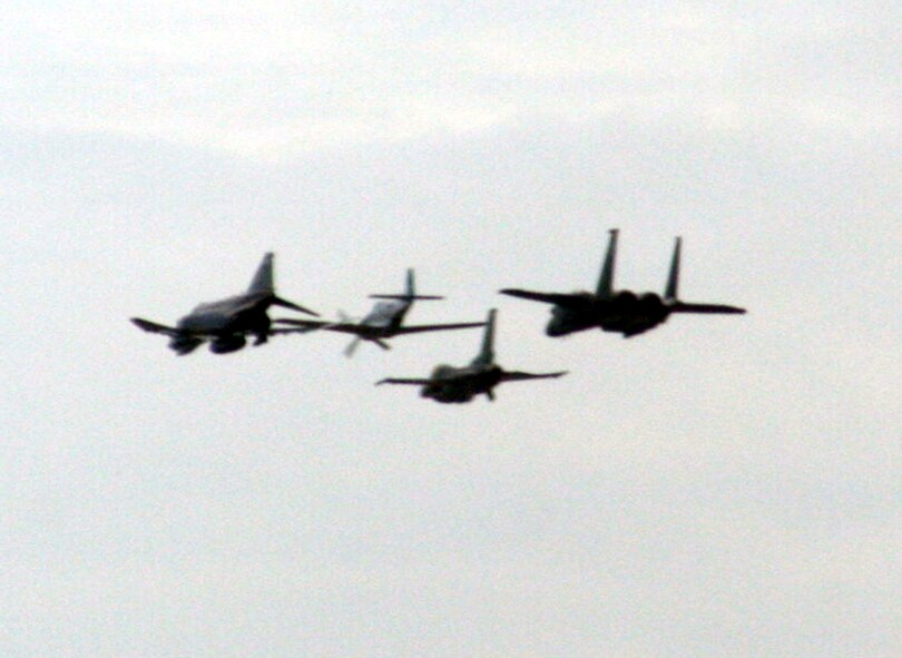 A formation of vintage and current Air Force planes fly in formation during the 2009 Scott Air Force Base Airshow on Sept. 19, 2009, at Scott AFB, Ill.  The airshow drew tens of thousands of people and featured a wide variety of aircraft on static display and in aerial performances.  (U.S. Air Force Photo/Tech. Sgt. Scott T. Sturkol)