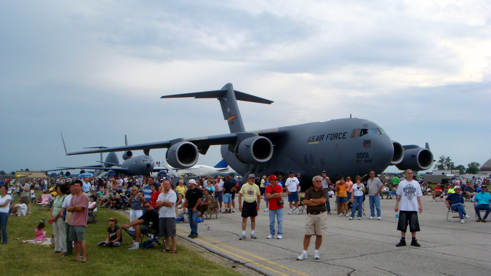 Attendees to the 2009 Scott Air Force Base Airshowmove around the air field on Sept. 19, 2009, at Scott AFB, Ill. A C-17 Globemaster III is seen in the background.  The airshow drew tens of thousands of people and featured a wide variety of aircraft on static display and in aerial performances.  (U.S. Air Force Photo/Tech. Sgt. Scott T. Sturkol)