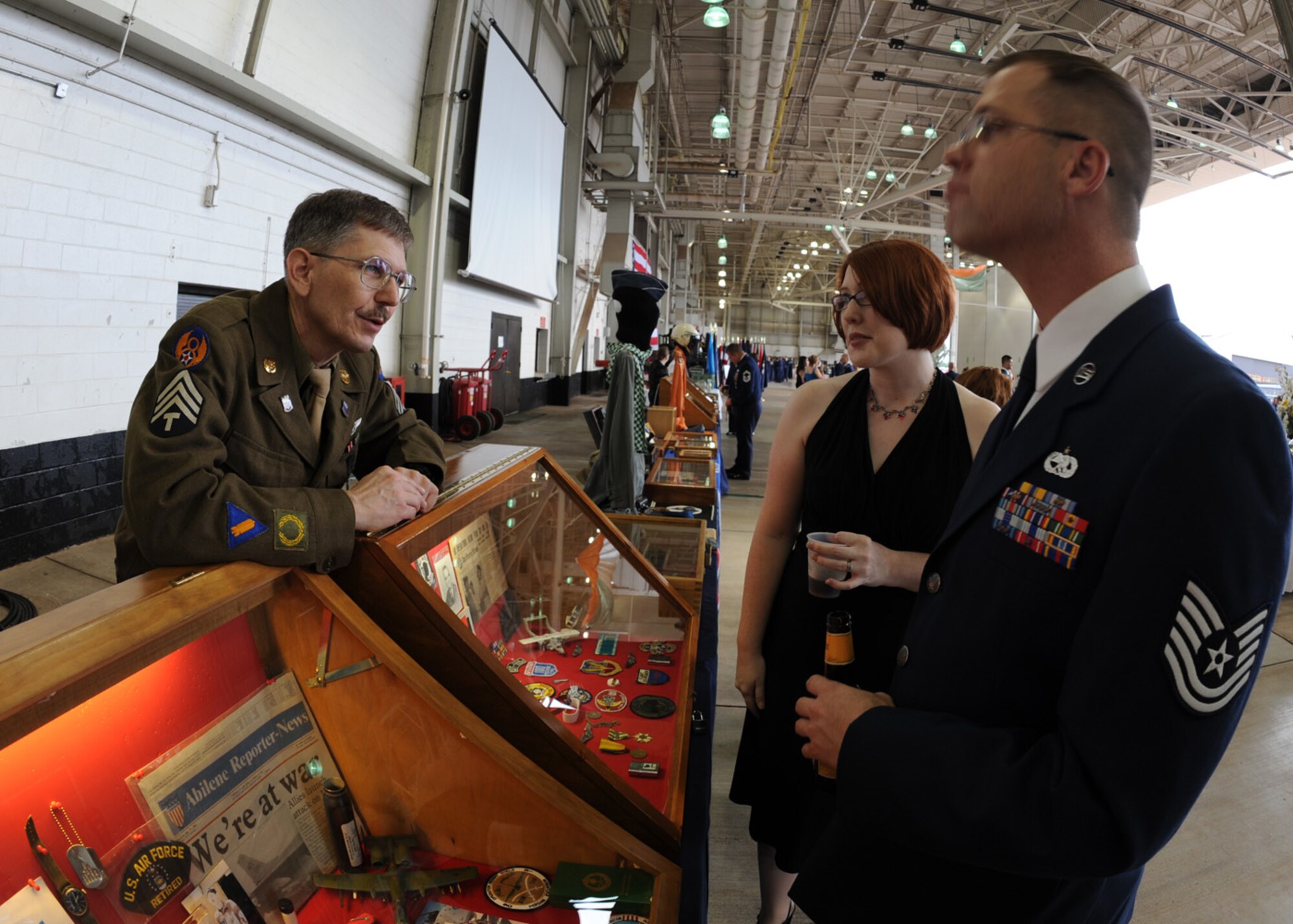 DYESS AIR FORCE BASE, Texas – David Vargo (left), exhibitor, discusses Air Force artifacts with dance attendees during the Air Force Hangar Dance here Sept. 18. Artifacts ranged from World War II era to present day, with 7th Security Forces Squadron exhibiting the latest advanced war-fighting weapons. The dance was held to celebrate the 62nd birthday of the Air Force with more than 425 guests. (U.S. Air Force photo by Senior Airman Jennifer Romig)