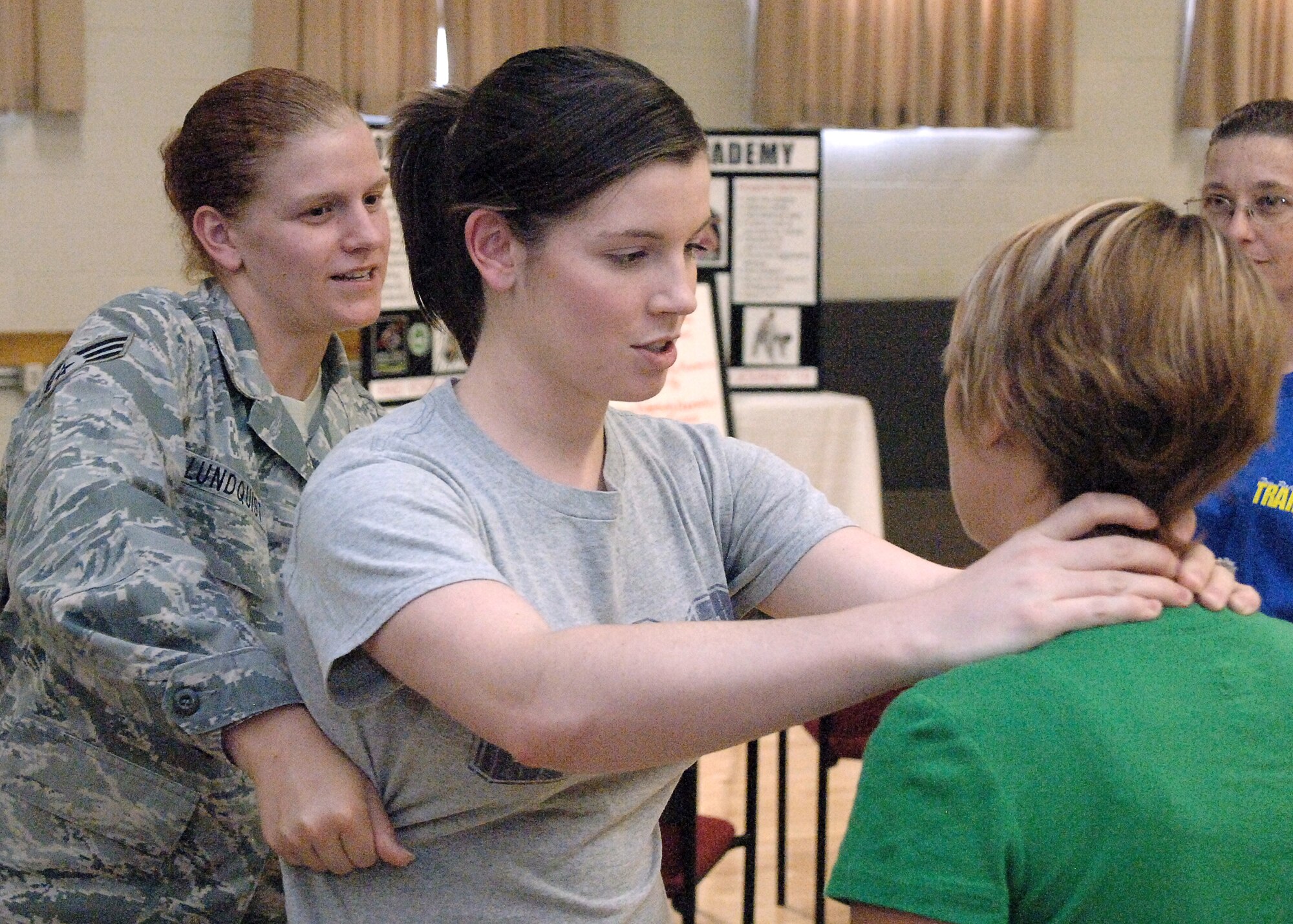 HOLLOMAN AIR FORCE BASE, N.M. -- Senior Airman Kaidy Lundquist, 49th Force Support Squadron, attempts to remove a simulated attacker, Anna Johnson, from her simulated victim, Brandy Waldschmidt, at a self protection class sponsored by the Sexual Assault Prevention and Response Program at the Community Activity Center here Sept. 12. The class taught self-escape techniques to create a window of opportunity and scanning patterns to help avoid a bad situation. (U.S. Air Force photo by Staff Sgt. Sanjay Allen)