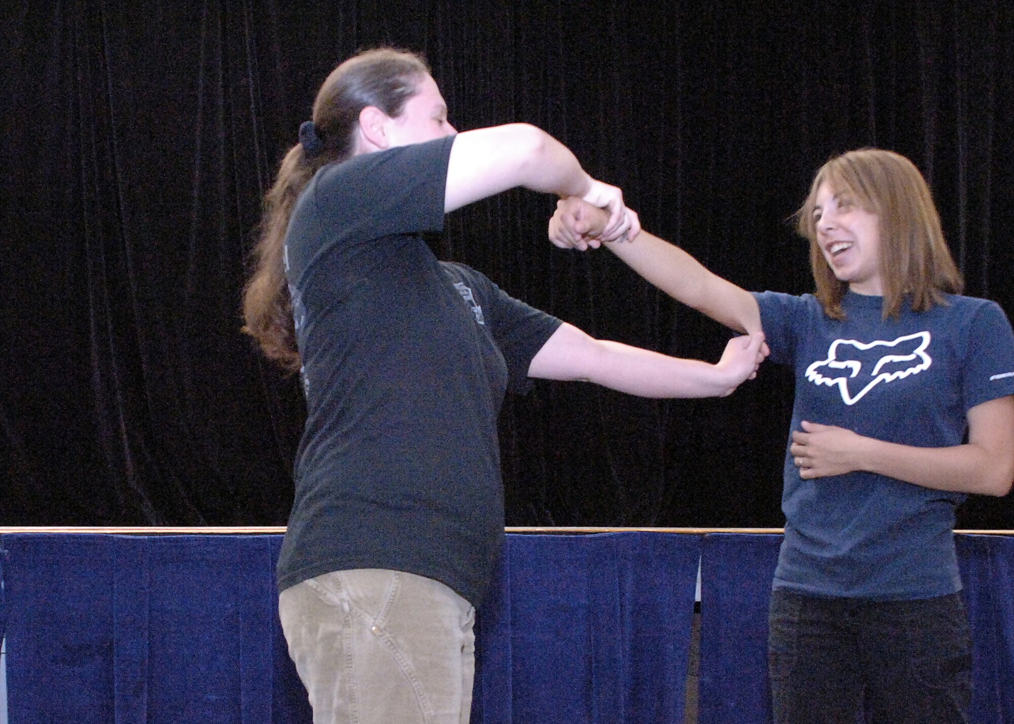 HOLLOMAN AIR FORCE BASE, N.M. -- Senior Airman Heather Evans, 49th Logistics Support Squadron, attempts to break away from her simulated attacker, Senior Airman Heather Prouse, 49th Medical Support Squadron, by pinching her upper arm in a self protection class sponsored by the Sexual Assault Prevention and Response Program at the Community Center here  Sept. 12. The class taught self-escape techniques to create a window of opportunity and scanning patterns to help avoid a bad situation. (U.S. Air Force photo by Staff Sgt. Sanjay Allen)