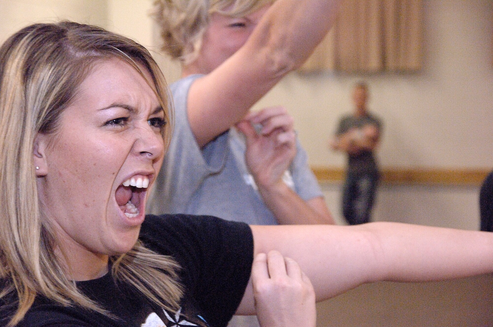 HOLLOMAN AIR FORCE BASE, N.M. -- Senior Airman Olivia Jaques, 49th Operations Support Squadron, pinches herself before practicing the breakaway move on her partner at a self protection class sponsored by the Sexual Assault Prevention and Response Program at the Community Center here Sept. 12. The class taught self-escape techniques to create a window of opportunity and scanning patterns to help avoid a bad situation. (U.S.  Air Force photo by Staff Sgt. Sanjay Allen)