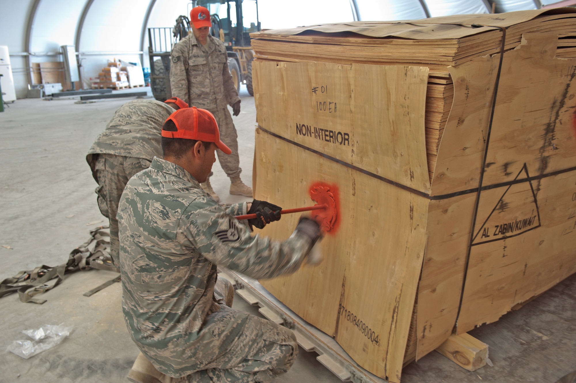 Staff Sgt. Dennis Urruchi marks a pallet for palletizing and shipping Sept. 15, 2009, at an air base in Southwest Asia. Sergeant Urruchi is a 1st Expeditionary RED HORSE Group electrical craftsman. He along with fellow servicemembers of the logistics and pallet build-up team, support all RED HORSE operations downrange by obtaining and shipping required equipment for mission success. Sergeant Urruchi is deployed from Peterson Air Force Base, Colo. (U.S. Air Force photo/Staff Sgt. Robert Barney) 