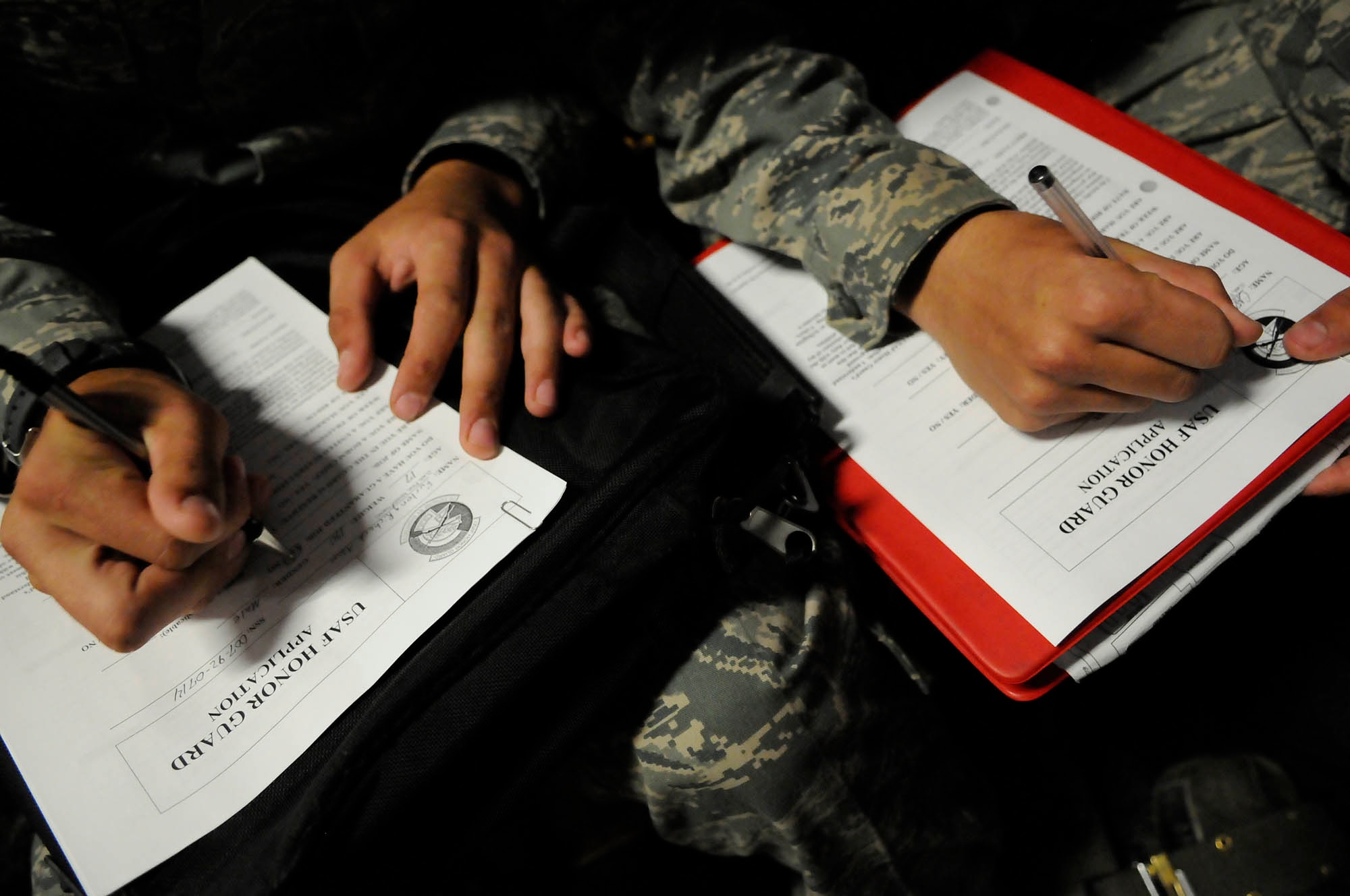 United States Air Force basic trainees fill out applications for the United States Air Force Honor Guard Sept. 19 at Lackland Air Force Base, Texas. The Drill Team along with members of the Honor Guard’s recruiting section travel to Lackland every other month in order to recruit new members into the Honor Guard. (U.S. Air Force photo by Staff Sgt. Dan DeCook)