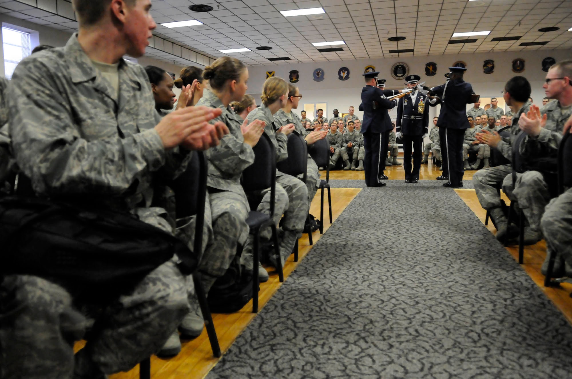 Members of the United States Air Force Honor Guard Drill Team perform for trainees at the Basic Training Reception Center Sept. 19 on Lackland Air Force Base, Texas. The Drill Team along with members of the Honor Guard’s recruiting section travel to Lackland every other month in order to recruit new members into the Honor Guard. (U.S. Air Force photo by Staff Sgt. Dan DeCook)