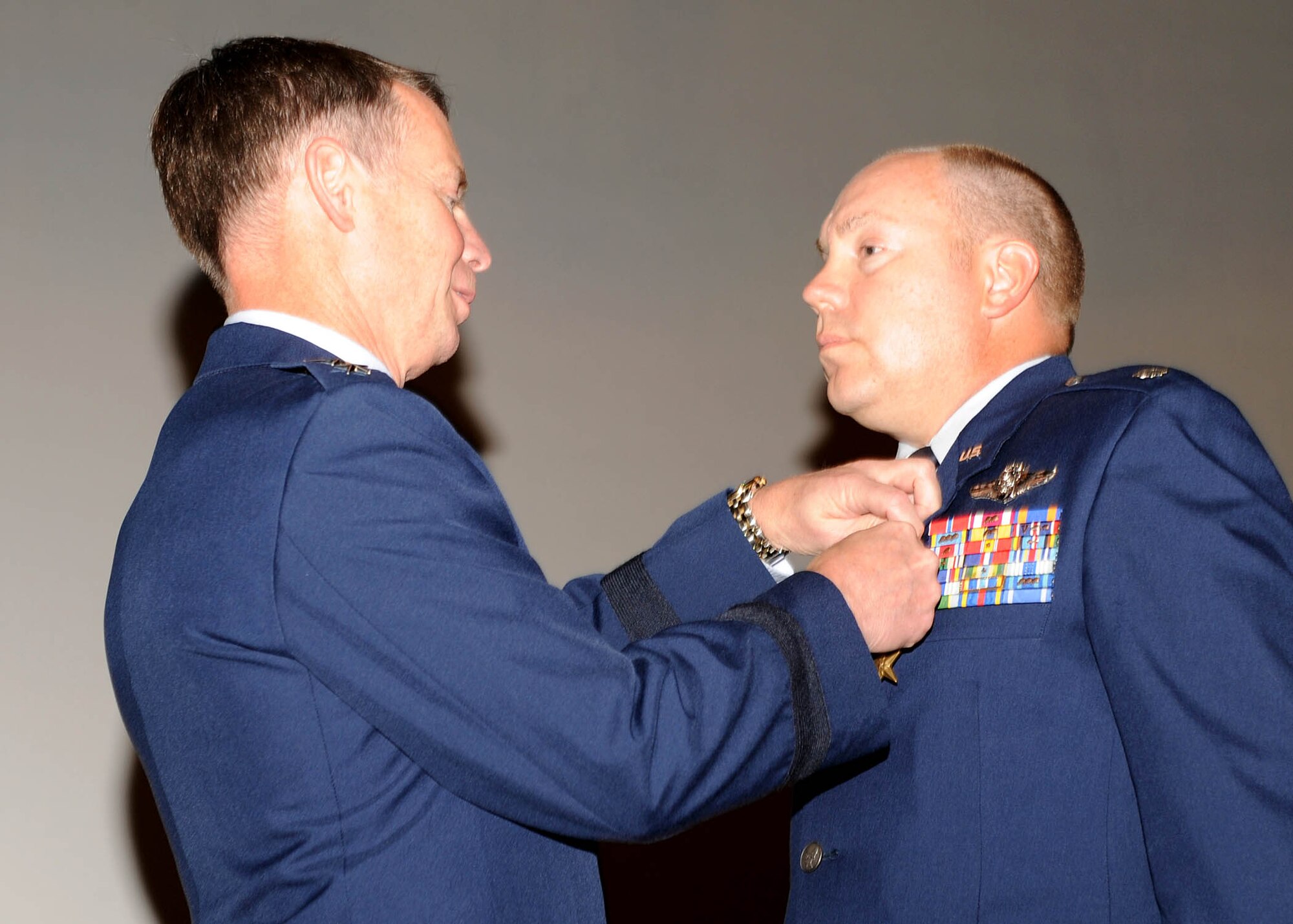 DAVIS-MONTHAN AIR FORCE BASE, Ariz. -- Lt. Col. Marc L. Cherry receives a Bronze Star Medal Sept. 14 from Lt. Gen. Glenn Spears, 12th Air Force (Air Forces Southern) commander. Colonel Cherry was awarded the medal for his accomplishments while deployed to Southwest Asia, as 609th Air and Space Operation Center, Combat Operations Division deputy director, from July 8, 2008 to July 1, 2009. During this period, Colonel Cherry led the largest Combined Air and Space Operations Center division, in support of Operations Enduring and Iraqi Freedom. He was responsible for synchronizing over 74,000 sorties providing close air support and actionable intelligence for the surge in Iraq and the increase of kinetic activity in Afghanistan.  His team provided continuous coverage for a 64-hour troops-in-contact engagement in Afghanistan which utilized 48 aircraft to deliver 60 weapons that were vital to ground forces gaining the initiative following an ambush.  Colonel Cherry also orchestrated a massive security umbrella of 400 sorties responding to 83 troops-in-contact engagements, eliminating 90 insurgents while protecting a generator designed to provide electricity to 2 million Afghans.  (U.S. Air Force photo by Senior Airman Jacqueline Romero)