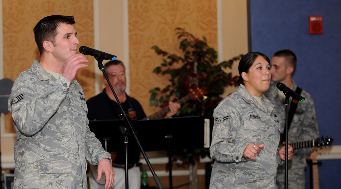 LANGLEY AIR FORCE BASE, Va. - Staff Sgt. Craig Bowman and Airman 1st Class Amy Aguilera, Air Combat Command Heritage of America Band vocalists, sing during Langley’s celebration of the Air Force’s birthday here Sept. 18.  The Bayside Enlisted Club held a celebration with music and food for the 62nd birthday.  (U.S. Air Force photo/Airman 1st Class Gul Crockett)
