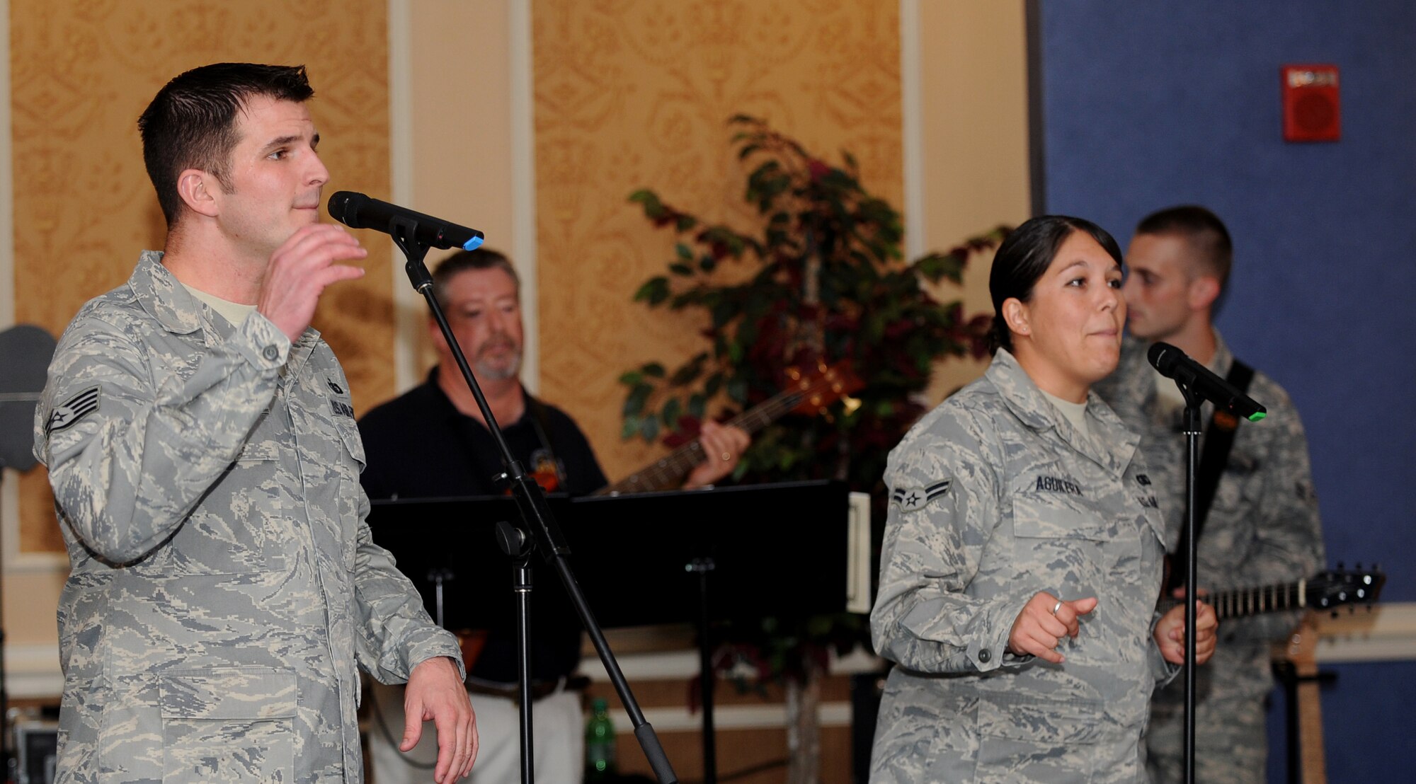 LANGLEY AIR FORCE BASE, Va. - Staff Sgt. Craig Bowman and Airman 1st Class Amy Aguilera, Air Combat Command Heritage of America Band vocalists, sing during Langley’s celebration of the Air Force’s birthday here Sept. 18.  The Bayside Enlisted Club held a celebration with music and food for the 62nd birthday.  (U.S. Air Force photo/Airman 1st Class Gul Crockett)