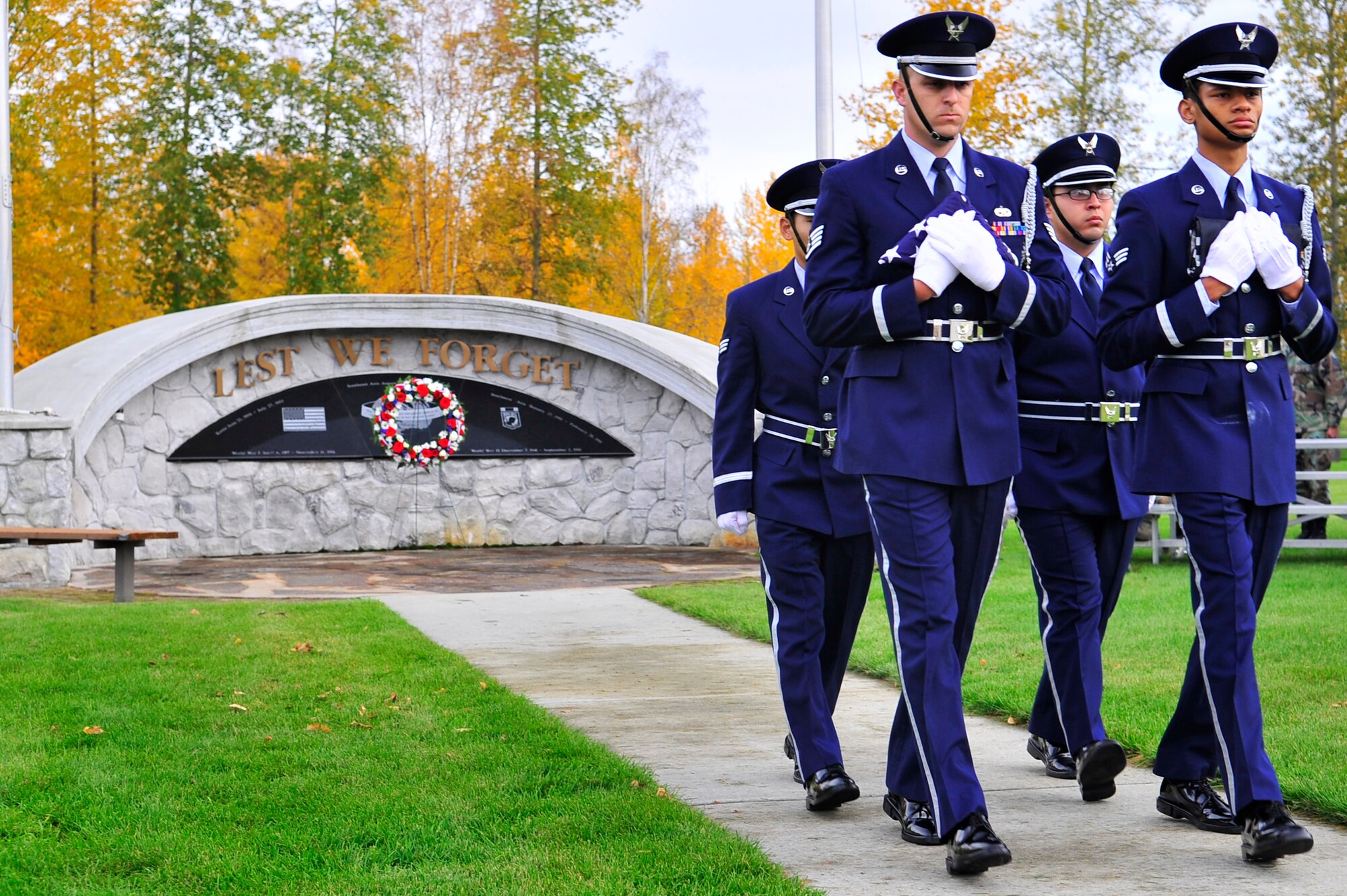 Airmen from the honor guard secure the flags during the Prisoners of War/Missing in Action ceremony Sept. 18, 2009, Eielson Air Force Base, Alaska. The POW/MIA ceremony pays tribute to those who were captured or have gone missing during war. Since World War I, over 296,800 Americans have been classified as POW/MIA. (U.S. Air Force photo/Staff Sgt. Christopher Boitz)