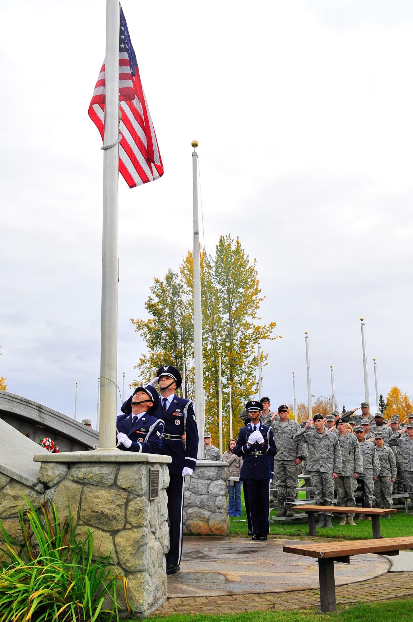 Airmen from the honor guard lower the flag during the Prisoners of War-Missing in Action ceremony Sept. 18, 2009, Eielson Air Force Base, Alaska. The POW-MIA ceremony pays tribute to those who were captured or have gone missing during war. Since World War I, over 296,800 Americans have been classified as POW-MIA. (U.S. Air Force photo/Staff Sgt. Christopher Boitz)