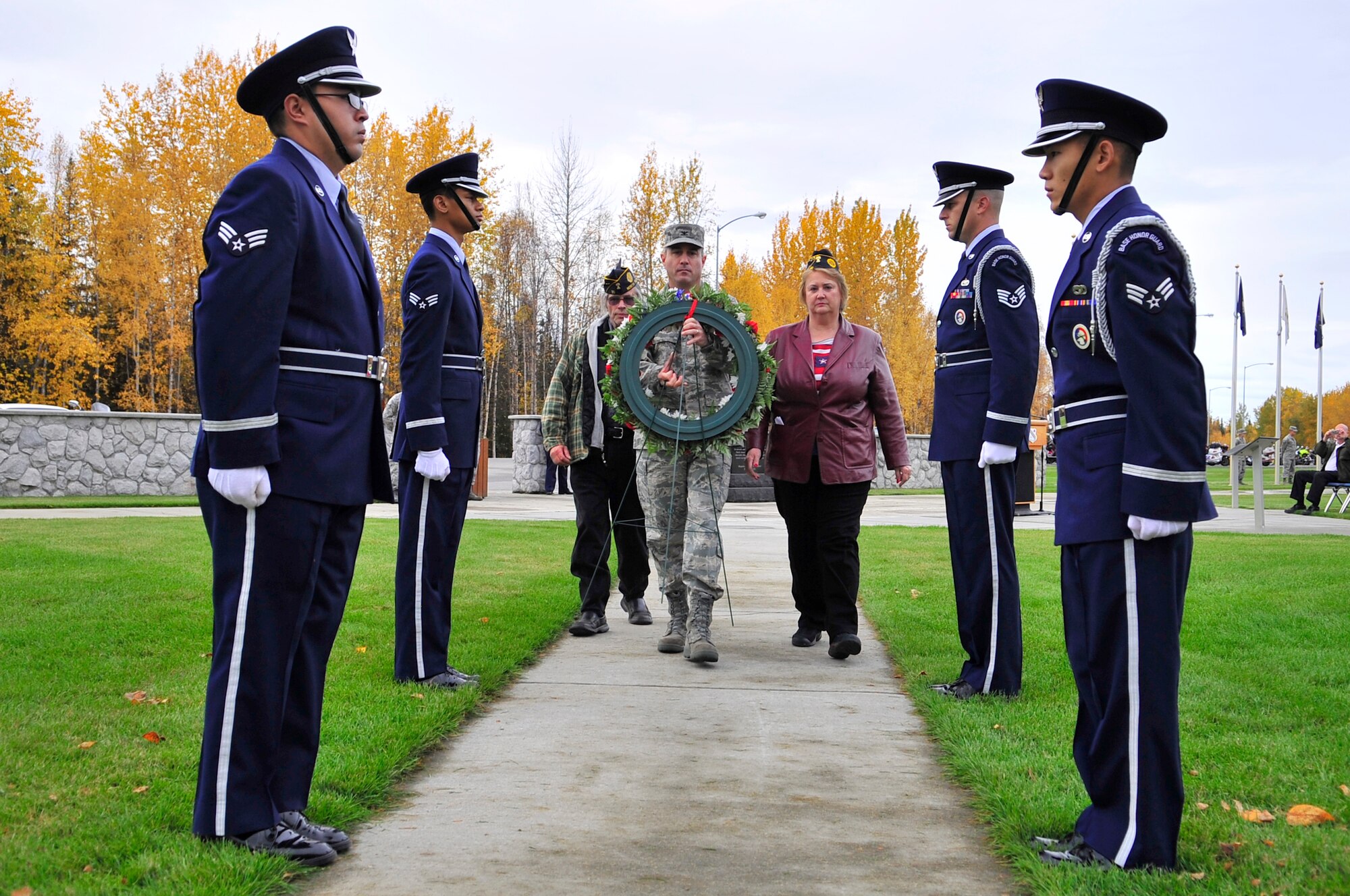 Col. Michael Jordan, Eric Anslow, and Terry Huisman place the wreath at the Prisoners of War-Missing in Action memorial during the POW/MIA ceremony Sept. 18, 2009, Eielson Air Force Base, Alaska. The POW/MIA ceremony pays tribute to those who were captured or have gone missing during war. Since World War I, over 296,800 Americans have been classified as POW/MIA. (U.S. Air Force photo/Staff Sgt. Christopher Boitz)