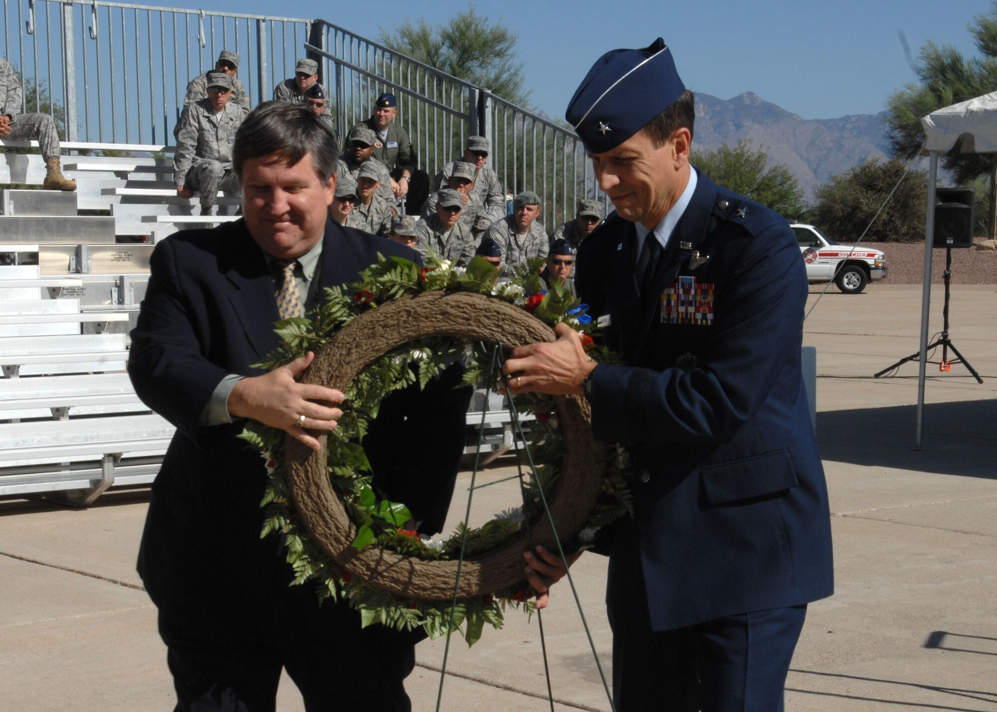 Dr. Jonathan Gardner, director of the Southern Arizona Veterans Affairs Health Care System, and Brig. Gen. Paul Johnson, 355th Fighter Wing commander, place a memorial wreathe at the POW monument during the POW-MIA memorial ceremony at Heritage Park Sept. 18.

The United States’ national POW/MIA recognition day is observed on the third Friday of September each year. Many Americans take the time to remember those who were prisoners of war (POW) and those who are missing in action (MIA), as well as their families. (U.S. Air Force Photo/Airman 1st Class Jerilyn Quintanilla)
