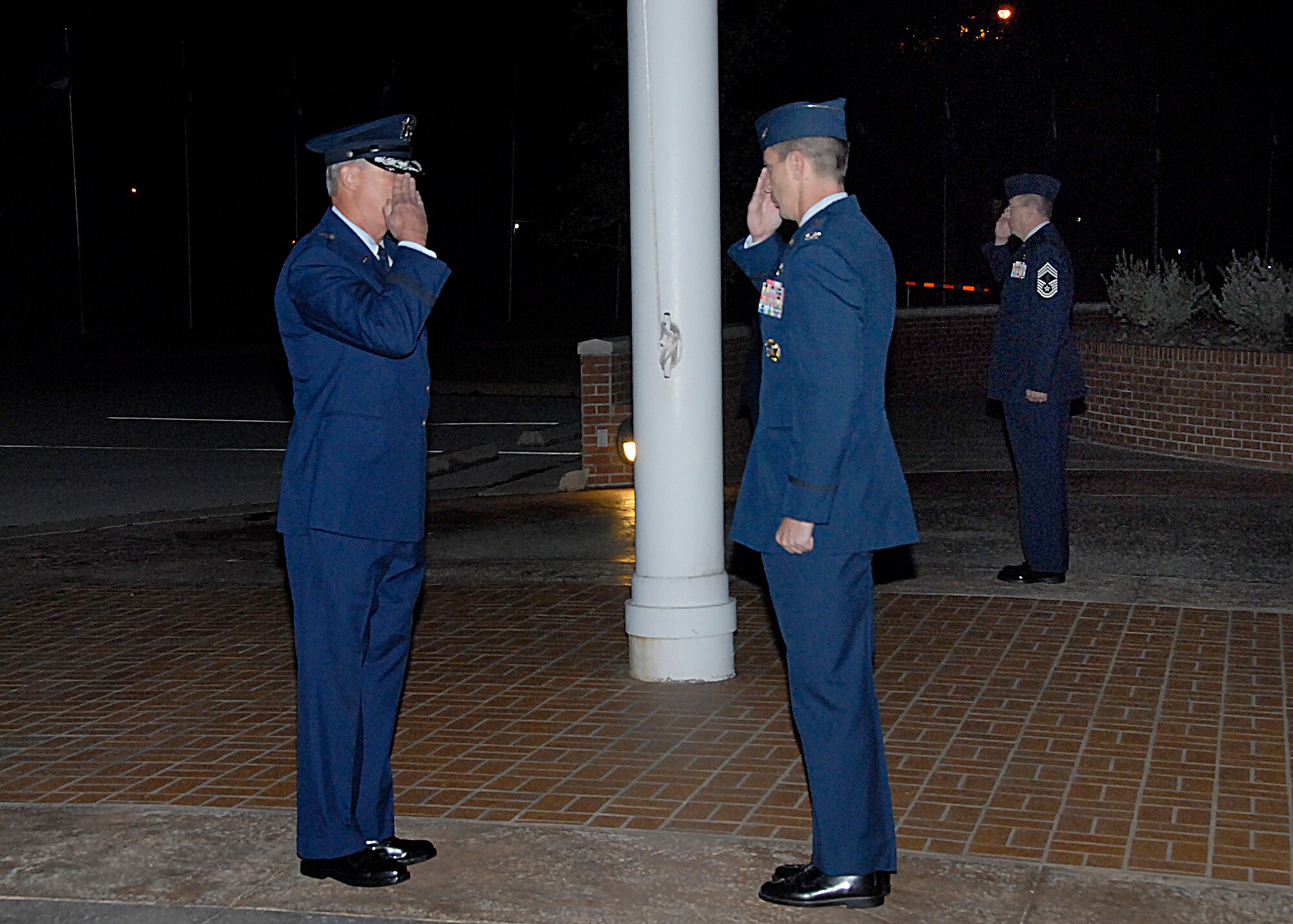 Brig. Gen. O.G. Mannon, 82nd Training Wing commander, salutes Col. Kevin Schneider, commander of the 80th Flying Training Wing, as they change the guard in a Flag Vigil in the early morning of Sept. 18. The flag vigil is one way Sheppard honored prisoners of war and troops missing in action on POW/MIA Recognition Day. (U.S. Air Force photo/Harry Tonemah)