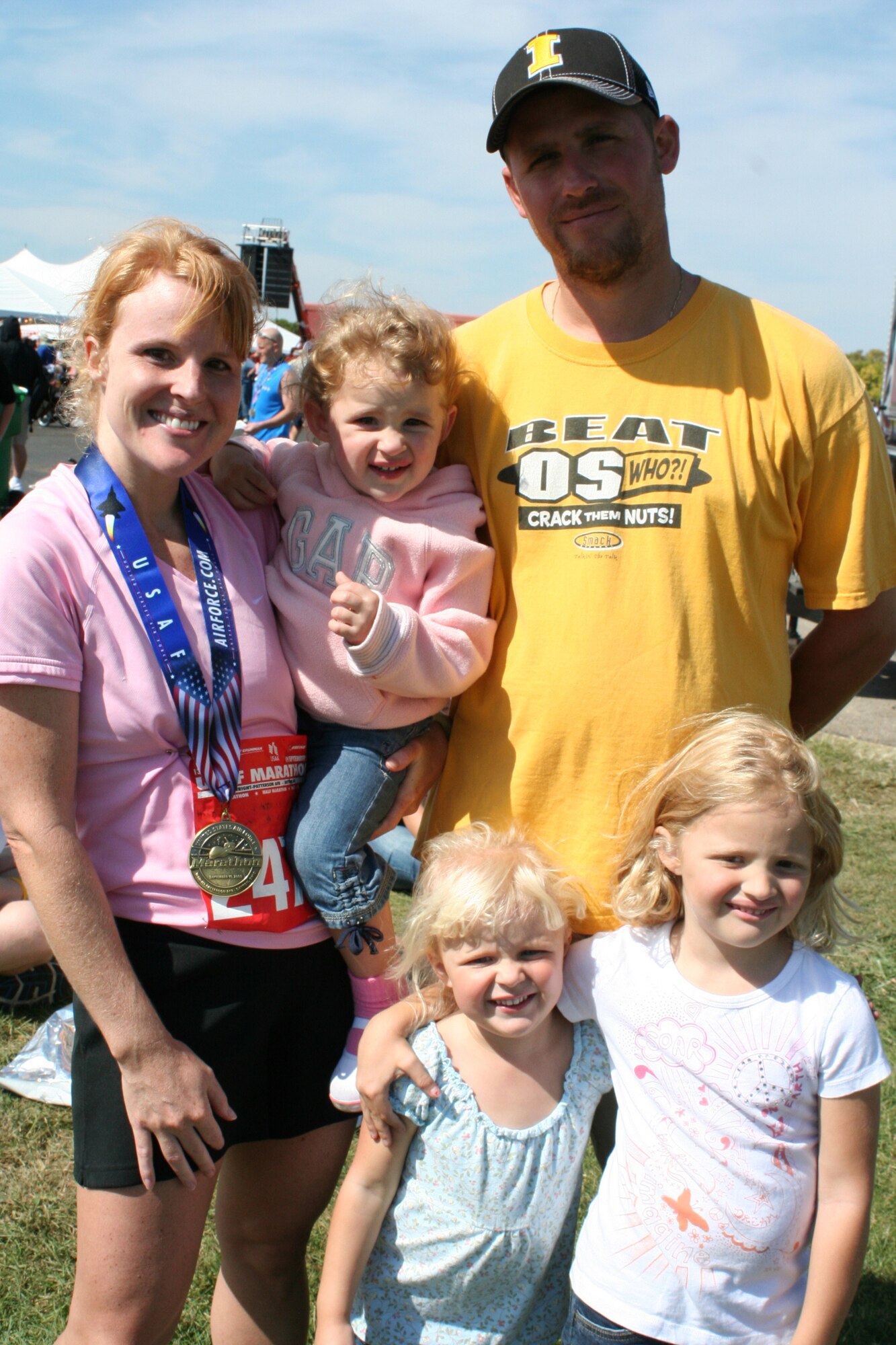 WRIGHT-PATTERSON AIR FORCE BASE, Ohio - Master Sgt. Rebecca Spencer, 445th Logistics Readiness Squadron, celebrates with her husband, Craig, and three daughters, Lauren, Megan, and Brook, after completing the 2009 Air Force Marathon at Wright-Patterson Air Force Base, Ohio, Sept. 19. Sergeant Spencer beat her previous marathon time by nearly four minutes coming in 143rd in female runners and 25th for her age group.  (U. S. Air Force photo/Capt. Rodney McNany)