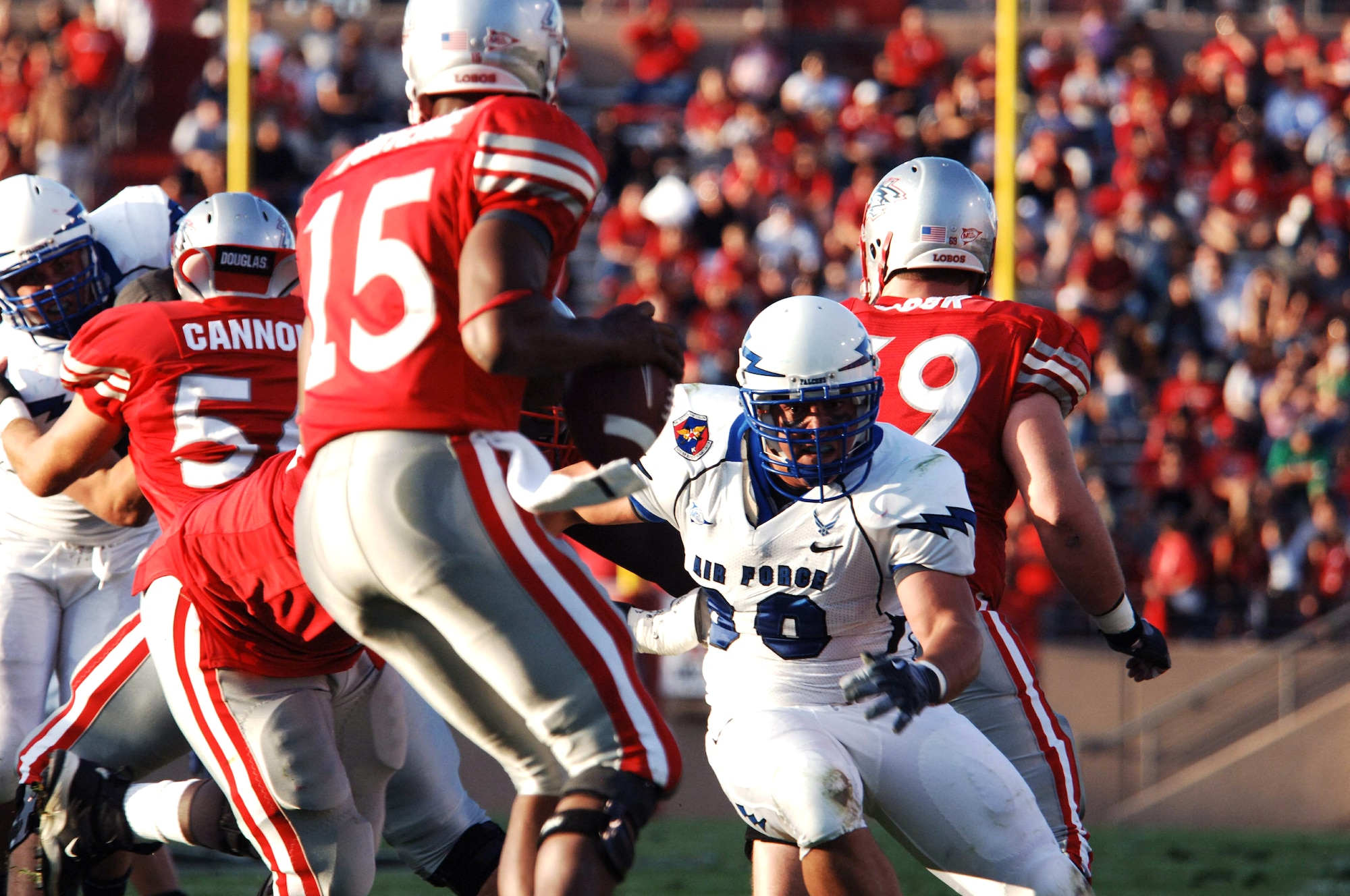 U.S. Air Force Academy defensive end Ryan Ricketts pressures New Mexico quarterback Donovan Porterie during football action Sept. 19, 2009, at Albuquerque, N.M. (U.S. Air Force photo/John Van Winkle)
