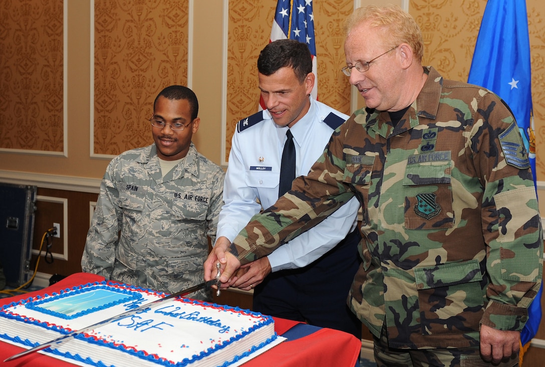 LANGLEY AIR FORCE BASE, Va. -- Col. Matthew H. Molloy, 1st Fighter Wing commander, and Airman 1st Class Markese Spain, Air Combat Command Heritage of America Band audio engineer, and Master Sgt. William Pook, 1st Civil Engineer Squadron emergency manager, cut the Air Force’s birthday cake here Sept. 18. Airman Spain is the newest Airman to join Langley’s team, while Sergeant Pook is Langley’s most seasoned career Airman. The Bayside Enlisted Club held a celebration with music and food for the 62nd birthday. (U.S. Air Force photo/Airman 1st Class Gul Crockett)