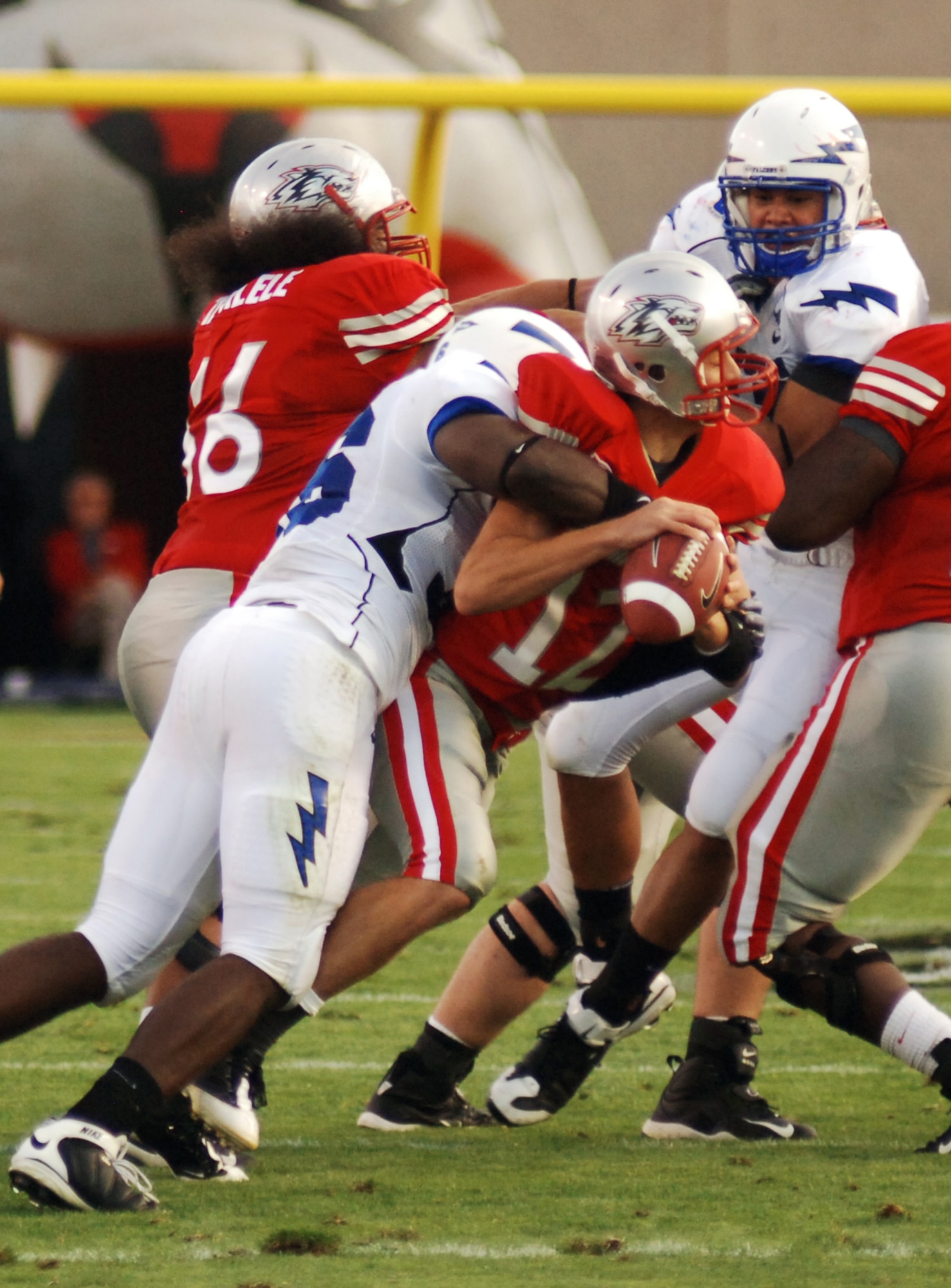 Falcons outside linebacker Andre Morris Jr. wraps up Lobos quarterback B.R. Holbrook for a 7-yard loss during the Air Force-New Mexico game at University Stadium in Albuquerque, N.M., Sept. 19, 2009. Morris ended the game with two sacks for 11 yards as the Falcons recorded a season-high four sacks in their 37-13 victory. (U.S. Air Force photo/John Van Winkle)