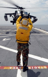 USS MESA VERDE, Panama — An Air department landing signal enlisted Sailor guides an Army UH-60 Blackhawk, assigned to Joint Task Force-Bravo, as it lifts off the flight deck of the amphibious dock landing ship USS Mesa Verde (LPD 19) during deck landing qualifications Sept. 14.  Mesa Verde is underway for Fuerzas Alidas (FA) PANAMAX 2009.  FA PANAMAX is an annual U.S. Southern Command joint and multi-national training exercise tailored to the defense of the Panama Canal, involving civil and military forces from around the world. (U.S. Navy photo/Mass Communication Specialist 3rd Class Patrick Grieco).