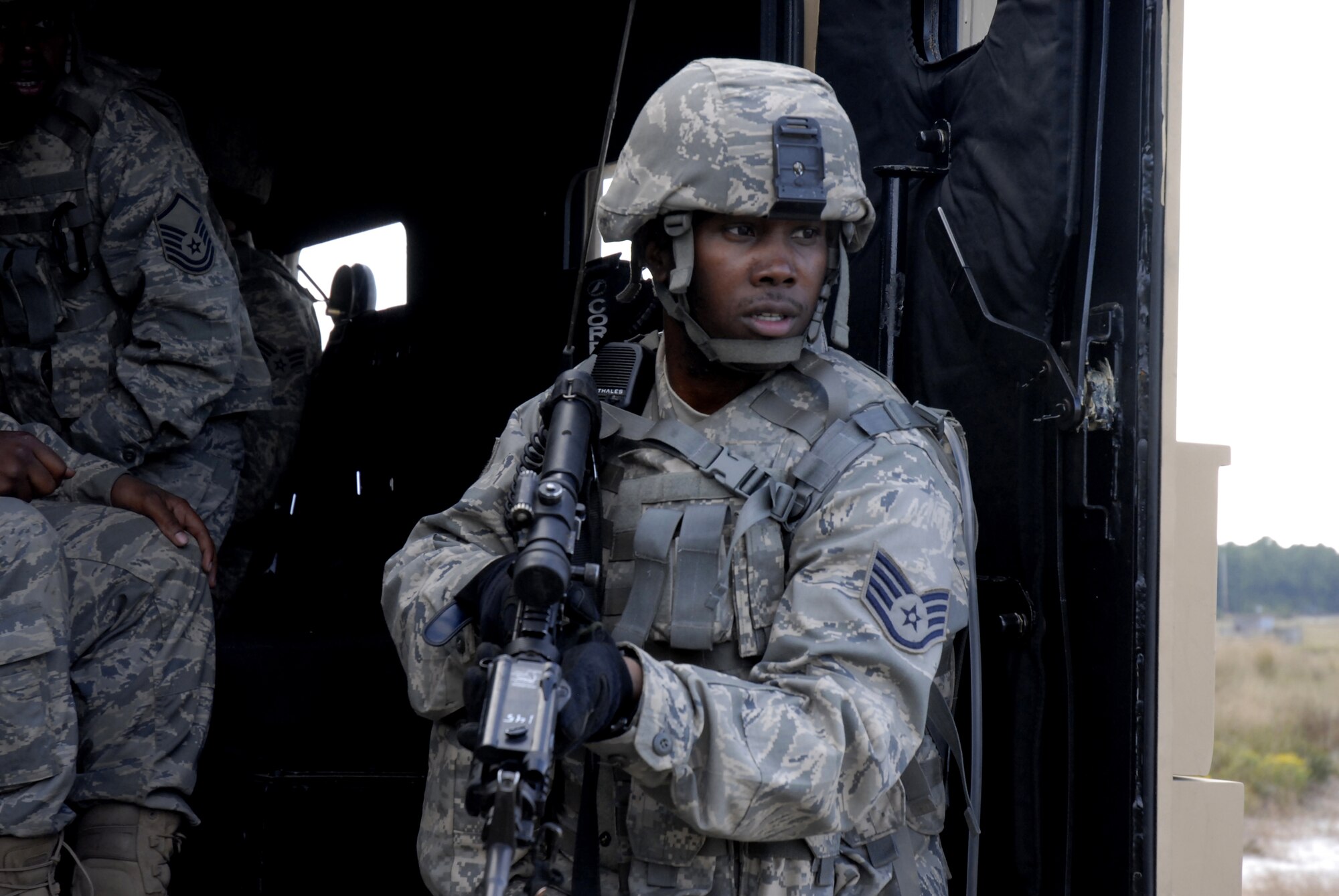 A security forces Airman remains vigilant while the wounded are being loaded into his vehicle after a simulated explosion of an improvised explosive device disabled a vehicle in their convoy during a pre-deployment training exercise conducted by the U.S. Air Force Expeditionary Center's 421st Combat Training Squadron at Joint Base McGuire-Dix-Lakehurst, N.J. on September 15, 2009.  (U.S. Air Force photo/Tech. Sgt. Paul R. Evans)