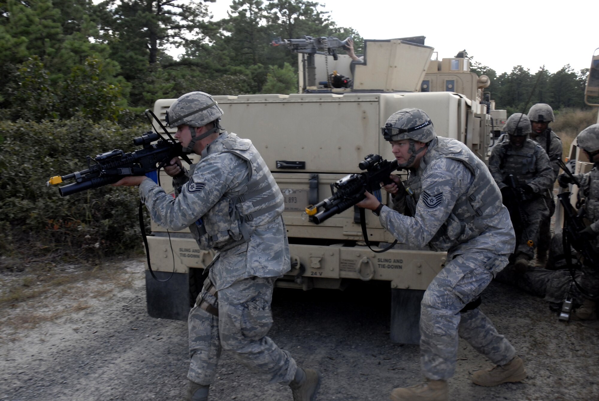 Security forces Airmen move to another position for cover to provide security while the injured are being evacuated after a simulated explosion of an improvised explosive device disables a vehicle in their convoy during a pre-deployment training exercise conducted by the U.S. Air Force Expeditionary Center's 421st Combat Training Squadron at Joint Base McGuire-Dix-Lakehurst, N.J. on September 15, 2009.  (U.S. Air Force photo/Tech. Sgt. Paul R. Evans)
